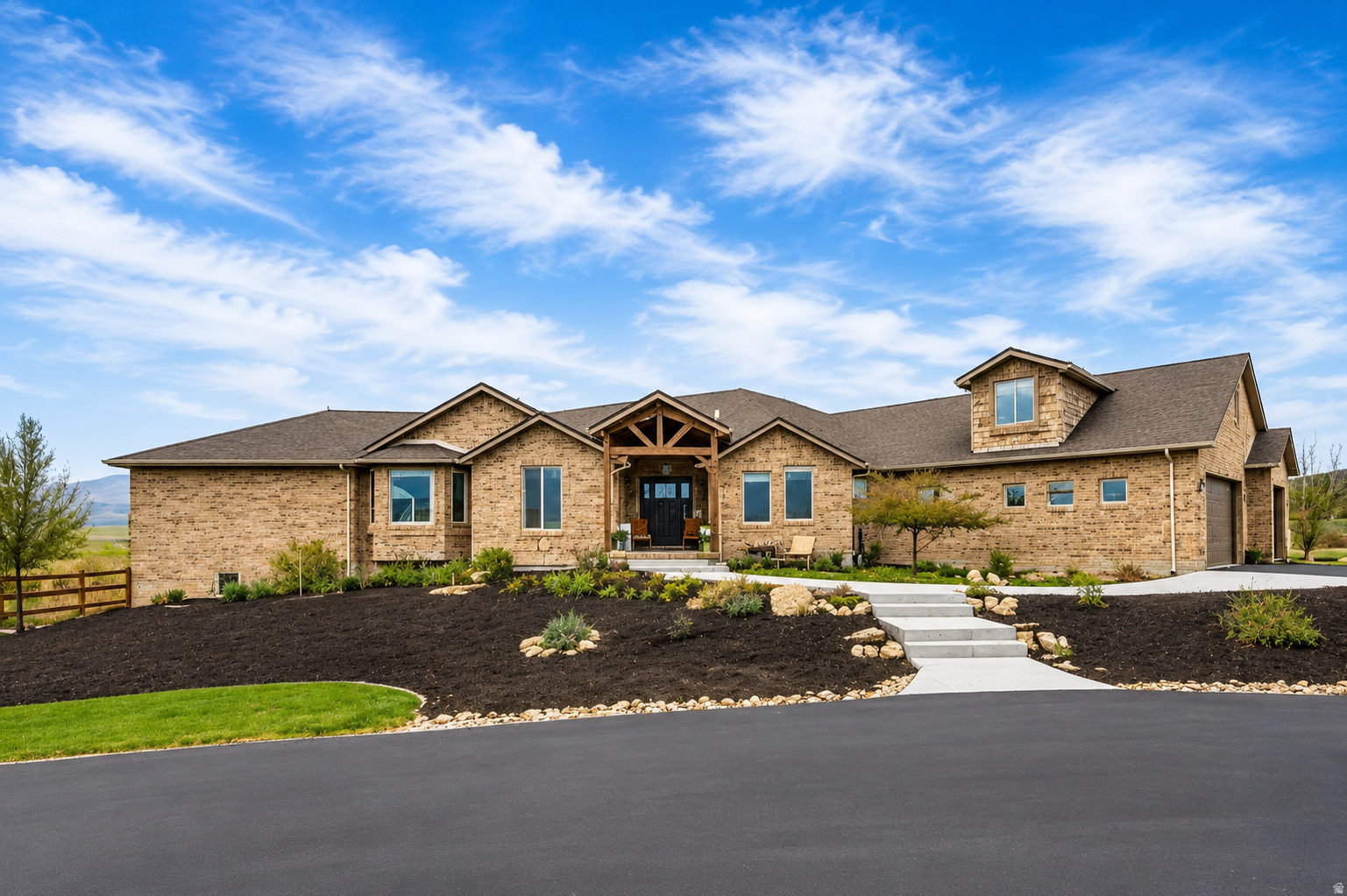 Custom luxury estate on 3 private acres with breathtaking mountain and valley views. This beautifully designed 6-bedroom, 4-bath rambler offers approximately 6,871 sq ft of thoughtfully crafted living space with high-end finishes throughout.   The main living area welcomes you with soaring vaulted ceilings, rich hardwood floors, and a dramatic floor-to-ceiling stone fireplace. The chef's kitchen features a Wolf gas cooktop, double ovens, granite countertops, custom cabinetry, a warming drawer, and a large walk-in pantry, making it ideal for both daily living and entertaining.  The luxurious primary suite features a Romeo & Juliet balcony, a spa-style bathroom with a jetted tub, an oversized shower with spray jets, dual vanities, and a walk-in closet. Enjoy additional features such as a private executive office, an oversized mudroom with built-ins, and a spacious loft perfect for play or relaxation. The fully finished daylight walkout basement provides flexible living space and potential for a second master suite. Outside, enjoy a 5-car garage with 220 power, RV parking, covered deck, stamped concrete patio, and room for animals or recreation on this expansive horse property.   Luxury, space, and views-this property truly has it all.