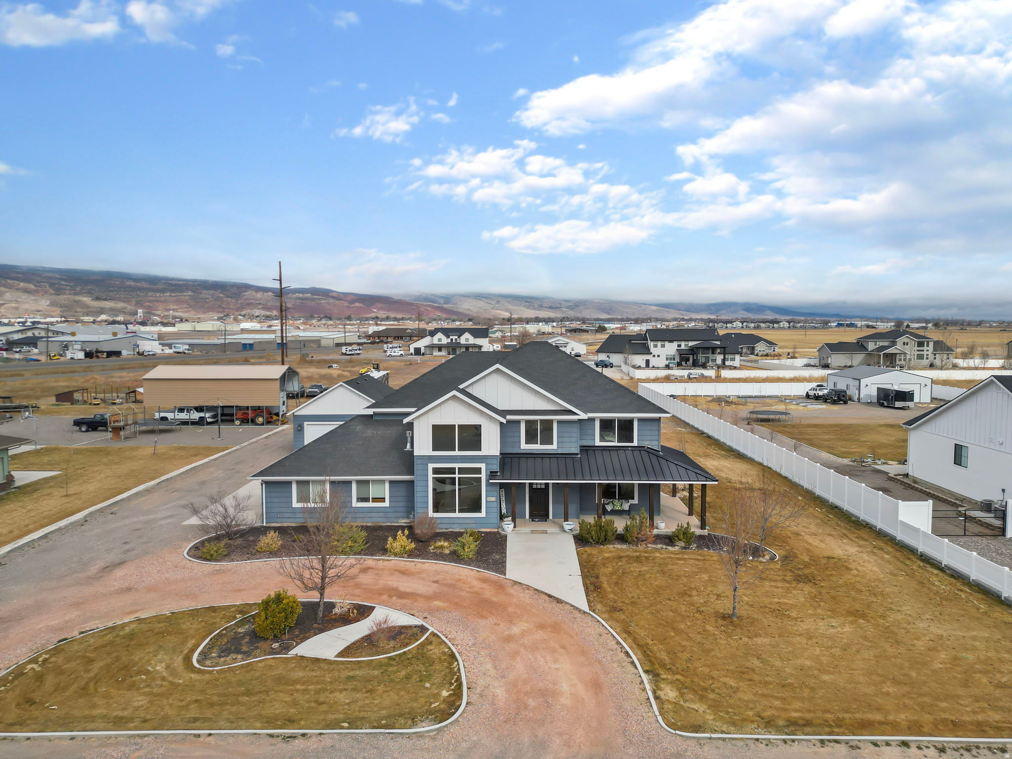 Located in one of Richfield's most desirable areas, in a newer neighborhood on the outside of town, this south-facing home sits on a large lot with room to grow and endless possibilities.  The entry is stunning with soaring two-story ceiling that opens into a bright living space filled with natural light from the large windows. This home has a beautiful open floor plan with a spacious kitchen plenty of cabinets, a large island, and seamless flow into the great room-perfect for everyday living and entertaining.  The primary suite has a with a large walk-in shower, soaker tub, beautiful vanity, and walk-in closet.   The yard is set up for gathering with a covered patio off the dining area, a fire pit, and additional patio space to relax and enjoy. The property also includes a substantial outbuilding ideal for storage, hobbies, or toys, plus extra shed space at the rear for even more storage.