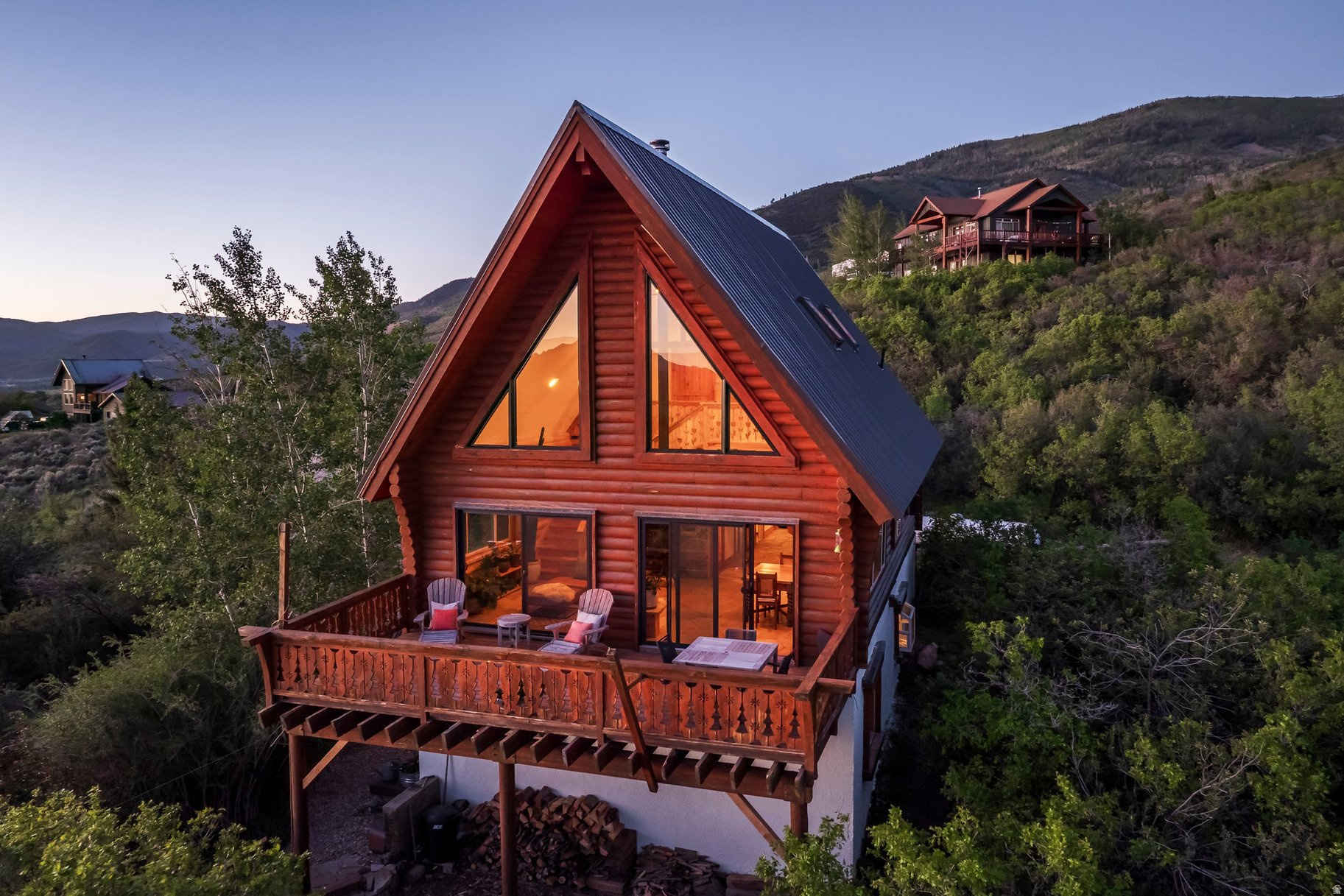 Set on 5 breathtaking acres in the Kamas Valley, this extraordinary handcrafted mountain property offers a rare blend of artisan craftsmanship, privacy, water rights, and panoramic views stretching from Mt. Timpanogos to Deer Valley and the Park City ski resorts. Designed and built by a master timber craftsman, the home showcases exceptional Swedish cope Douglas fir log construction, hand-quarried Park City sandstone floors and countertops, custom woodwork, radiant floor heat, passive solar design, and a vintage WWI-era Heatrola stove. The beautifully updated 4-bedroom residence has undergone extensive improvements from 20222026, including new Andersen windows and doors, a new metal roof, refreshed interiors, custom cabinetry and closets, updated outdoor living spaces, and professionally maintained landscaping with fruit trees, gardens, drip irrigation, and stone terraces.  Offered with Lots 83 and 84, this unique legacy property includes established Weber River water shares, two productive wells, a greenhouse with utilities and irrigation, a 4,000-gallon water storage system, and a separately recorded buildable lot with incredible ski area views. Ideal for horses, recreation, or a private mountain retreat, the property offers direct access to the Uinta Mountains for year-round adventure including hiking, horseback riding, fishing, skiing, and camping. Rarely does a property combining this level of craftsmanship, infrastructure, land, and natural beauty become available.