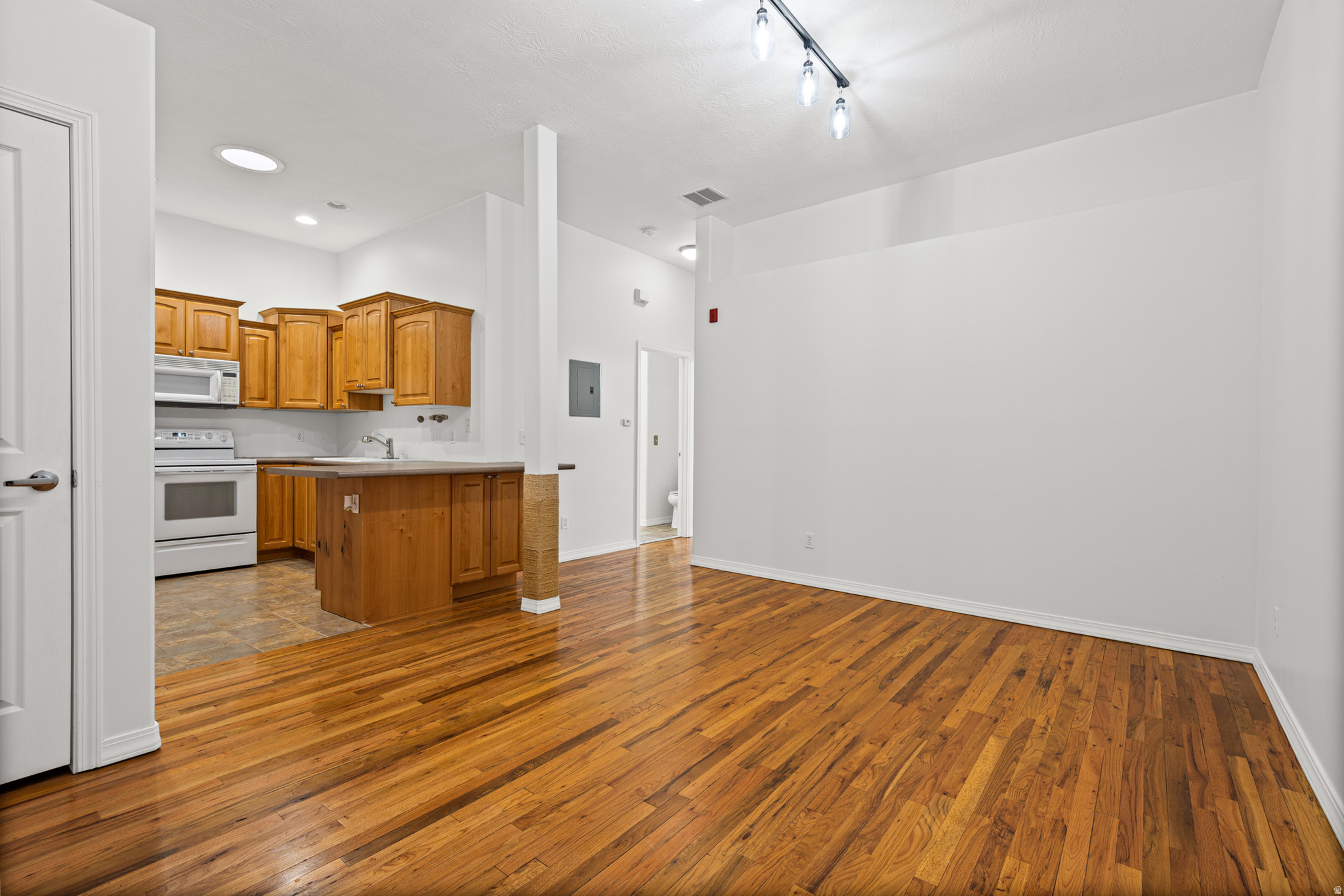 Downtown Bountiful living doesn't get more dialed in than this - and once you see it in person, you'll understand why. Sure, it's one bedroom - but don't let that fool you. The space is smartly designed with great storage throughout, and the bedroom itself has the kind of closet situation that actually makes sense. Soaring ceilings and skylights let natural light in, and a charming Juliette balcony (see attached plans in listing) off the bedroom gives you that fresh air moment every morning without leaving your pajamas behind. The bathroom? Set up as a Hollywood bath - two completely separate, private vanities that make sharing a space feel surprisingly luxurious. The kitchen is spacious and thoughtfully laid out with a generous step-in pantry that most condos would envy. Washer and dryer are included and in-unit, so laundry day stays simple. One-level living throughout, with elevator access to the building - because nobody should have to muscle a couch up two flights of stairs. The building is incredibly quiet, and the secured entry is a bonus for any resident. And then there's the location, which honestly might be the whole story. Downtown Bountiful's Main Street is the real deal - one of those rare, walkable, old-school main streets that still has some history and soul. (Charming enough that Hallmark has used it as a filming location more than once, if you're into that kind of thing.) Steps from local  Indian and pizza restaurants, coffee shops, the ice cream shop voted Best in Utah, and what many people will tell you are the best bagels in the state of Utah and beyond. A farmers market sets up literally a block away for six months out of the year. Parks, shops, and community all within easy reach - the kind of neighborhood where you actually want to be outside. This is the perfect home for the professional who wants low-maintenance living without sacrificing style, the downsizer who refuses to give up a good kitchen, or anyone who's realized that location and livability matter more than square footage. Schedule a showing and come see it - I think it'll surprise you. Smart layout. Incredible location. Downtown Bountiful at its best. Sale of this home is part of a 1031 Exchange