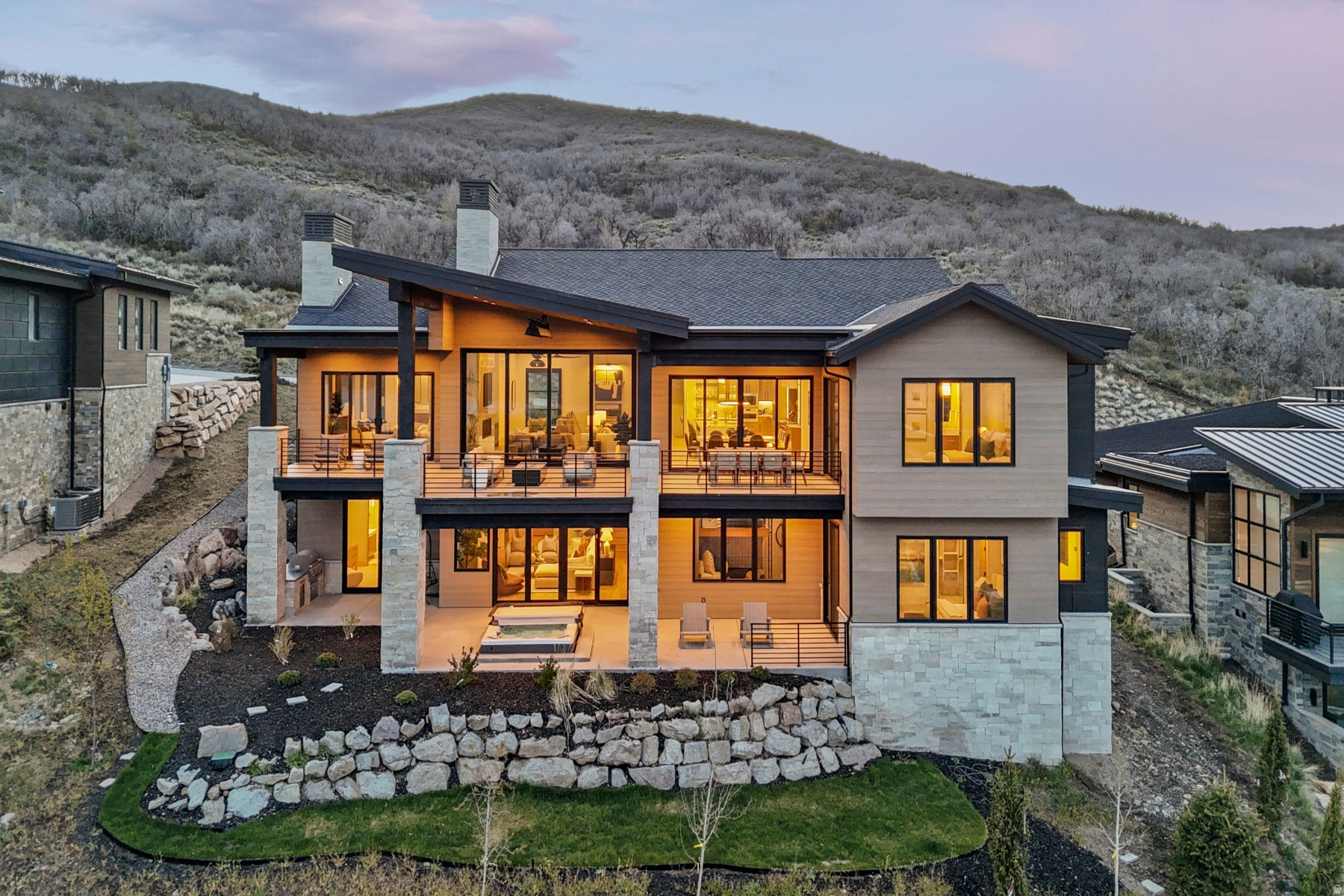 Positioned along the coveted "Gold Coast" of SkyRidge and on the golf course, this newly completed 2025 mountain modern estate spans nearly 7,000 sq ft with 6 bedrooms and 7 bathrooms, offering a rare blend of architectural excellence, carefully curated furnishings, privacy, and sweeping views of Jordanelle Reservoir and Deer Valley Resort. Located within one of Park City's most sought-after resort enclaves, the home is designed for those who value both discretion and elevated living.The open-concept main level features walls of glass and expansive pocket doors that seamlessly connect indoor and outdoor spaces. Designed for effortless main-level living, the home offers dual primary suites in separate wings for optimal privacy. A chef's kitchen with Sub-Zero and Wolf appliances anchors the kitchen and great room, all oriented to capture unobstructed alpine, lake, and golf course views. Nearly 1,600 sq ft of heated outdoor living includes an upper deck with fire pit and overhead heating, plus a lower patio with built-in hot tub and outdoor kitchen. A fully integrated Control4 system provides seamless control of lighting, climate, security, and entertainment.The lower level serves as a private retreat with three en-suite junior suites and a bunk room, along with a theater, game room, fitness studio, wet bar, and multiple gathering areas. The 3-car garage has a lock off bay and mudroom with separate entrance to the home. SkyRidge amenities include a championship golf course, two-tier driving range, private clubhouse with pool and fitness facilities, equestrian center, dining, and private shuttle access to Deer Valley East Village.This is a limited opportunity to secure a premier legacy property within one of North America's most dynamic luxury resort markets where elevated design, effortless access, and year-round alpine lifestyle converge.