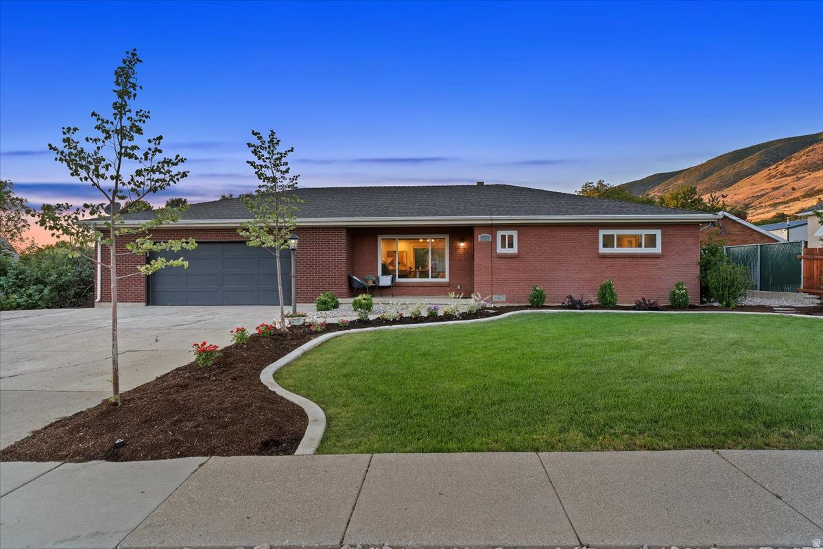 Don't let the charming brick exterior fool you-this home is much larger than it appears. Offering nearly 4,000 square feet on a hard-to-find half-acre lot, this beautifully updated rambler provides space, flexibility, and opportunity in one of Centerville's most desirable locations.  The main level features an inviting open layout with spacious gathering areas, abundant natural light, and extensive updates throughout. Much of the interior has been recently painted, creating a fresh, move-in-ready feel. The remodeled kitchen showcases quartz countertops, white cabinetry, stainless steel appliances, a double oven, large island, and an incredible walk-in pantry. Upstairs you'll find three bedrooms and three bathrooms, including two bedrooms with their own private bathrooms, creating a rare dual-primary-suite setup. The primary bathroom has been completely remodeled within the past 30 days, offering a beautiful, modern retreat.  The fully finished walkout basement offers exceptional flexibility with its own exterior entrance, second laundry room, two bedrooms, two bathrooms, and a full second kitchen with hookups for a range and refrigerator, abundant cabinetry, and generous counter space. Whether you're looking for multi-generational living, a private space for extended family, guest accommodations, or potential ADU/rental income, the lower level is well-equipped to meet your needs.  Outside, the oversized garage is complemented by abundant parking and a large rear parking area with room for RVs, trailers, boats, work vehicles, or future expansion. The half-acre lot offers endless possibilities with plenty of space to add a shop, garden, pool, sports court, or simply enjoy the privacy and open space. Mature trees, mountain views, and convenient access to schools, parks, shopping, and freeway access complete this exceptional property.  Homes offering this much space, flexibility, parking, and future potential on a half-acre lot are becoming increasingly difficult to find.