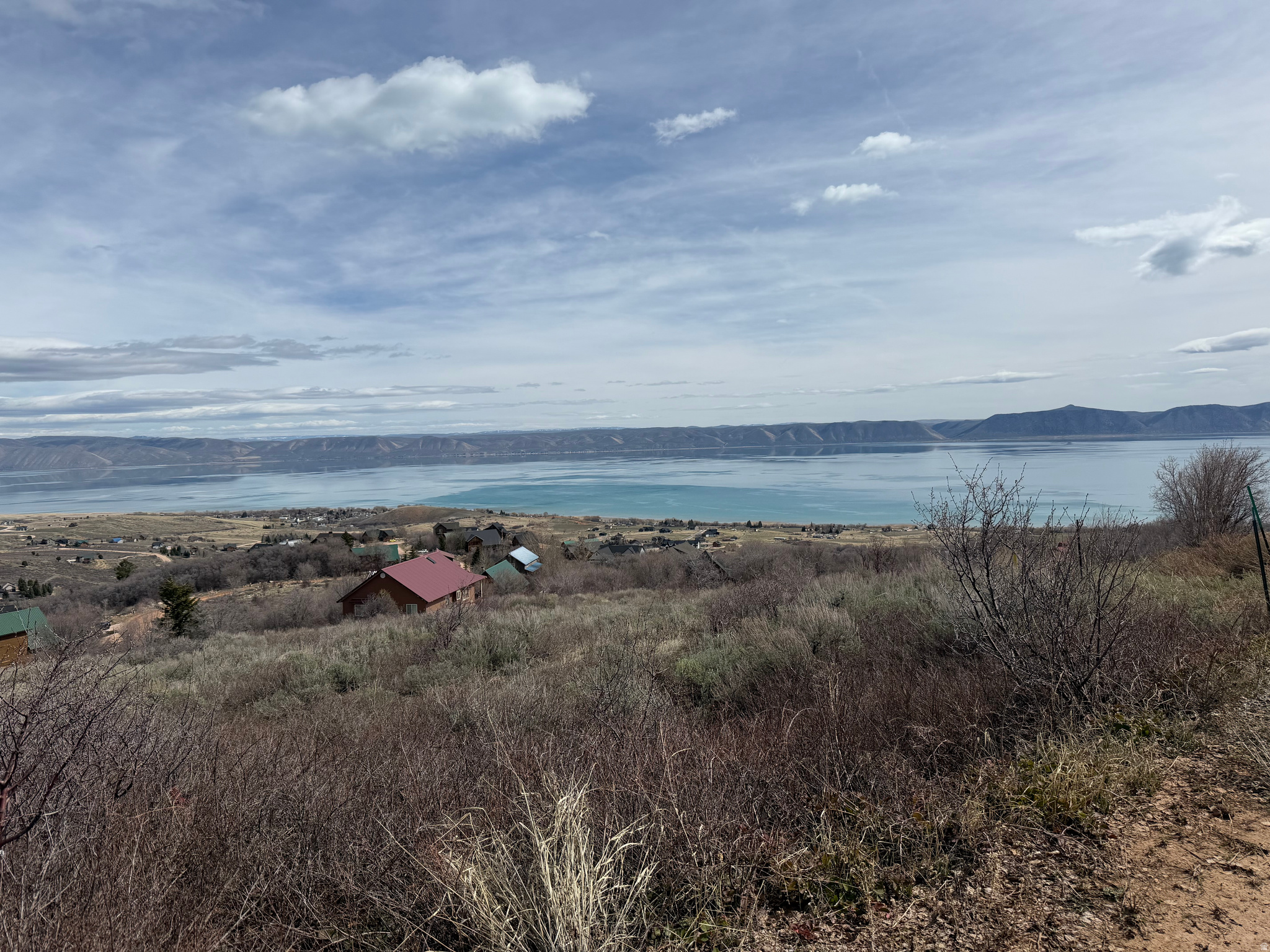 PRICE REDUCTION! Expansive, wide lake views from this spacious upper Bear Lake West lot. Literally so wide that the water couldn't fit in the camera's frame at once! Thicker trees on the back of the lot to ensure more privacy and beautiful fall colors. Also north side of lot borders common ground and then past that is National Forest! Great spot for a second home or year-round primary residence! Already a gravel approach and driveway on the west side of the lot. Survey stakes visible on west corners. No short term rentals. Come make this beautiful lot yours today!
