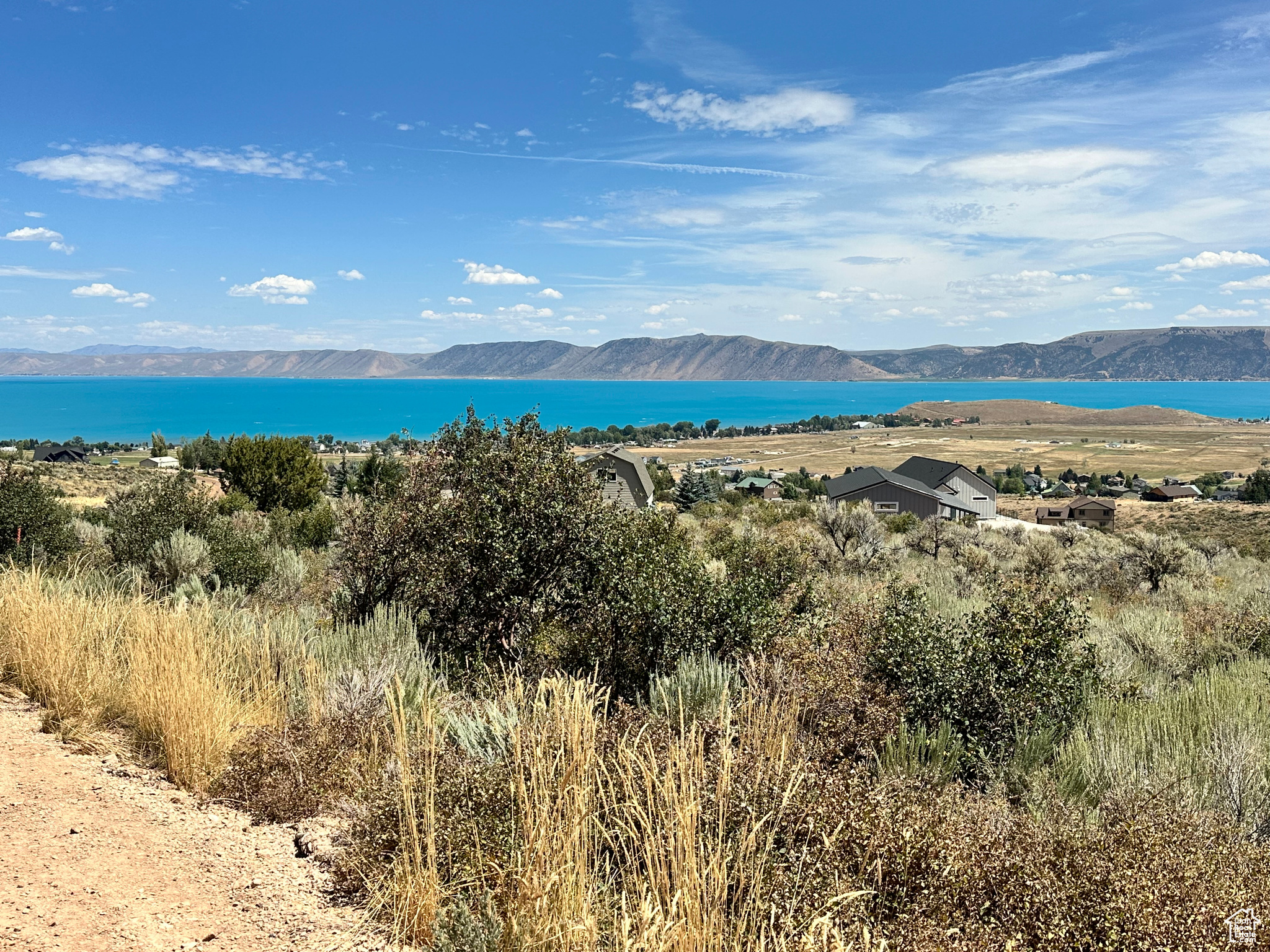 Don't miss out on this lot that has amazing views of Bear Lake! Nice and mostly flat acre of land. Land has already been surveyed and is ready to build on! Get your offer in today!