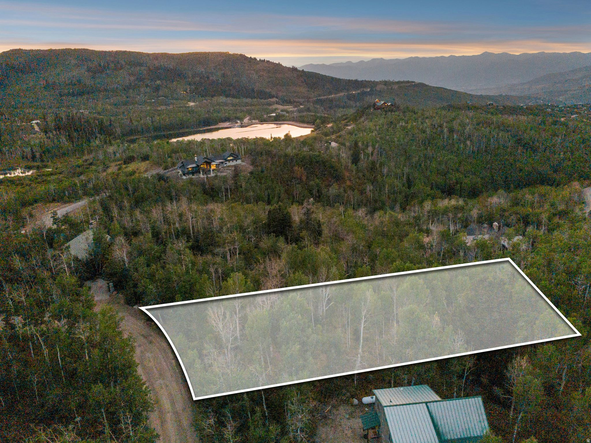 SURVEY, TOPOGRAPHY & SOIL TESTING COMPLETED! Build your dream mountain retreat on this heavily wooded 1-acre lot in Timber Lakes, offering year-round access, utilities, and sweeping Wasatch Back and Heber Valley views-all just 1 hour from Salt Lake City. Located in a private, guard-gated community 7 miles from Heber City and 35 minutes to Park City, this south-facing downhill lot is ideal for a walkout/daylight basement and captures abundant natural light and panoramic scenery. Enjoy easy access on maintained roads just  mile from pavement, making it perfect for full-time living, a vacation home, or investment property. Residents benefit from direct access to the Uinta National Forest for snowmobiling, ATV riding, hiking, and year-round recreation, surrounded by wildlife, streams, and lakes.