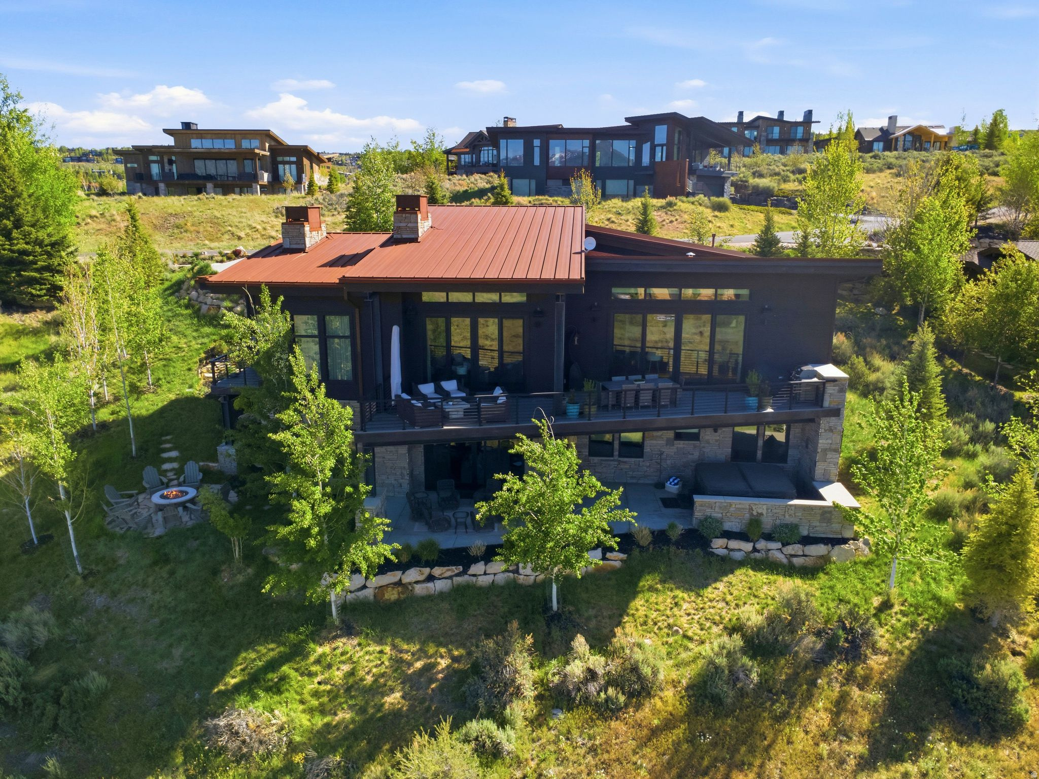 Modern mountain elegance meets effortless living in this beautifully crafted Promontory residence. Ideally positioned on a 0.43-acre homesite near Promontory's Equestrian Gate, the home captures sweeping ski mountain views and overlooks open space, creating a sense of privacy and connection to the surrounding landscape.  Thoughtfully designed with 4 bedrooms, 6 bathrooms, two living areas, an office, and over 4,000 square feet of living space, the home blends sophisticated contemporary finishes with warm, inviting interiors. The great room features soaring ceilings, exposed steel beams, a dramatic floor-to-ceiling stone fireplace, and expansive windows that frame the views beyond.  At the heart of the home, the chef's kitchen is designed for both everyday living and entertaining, showcasing a stunning waterfall island, premium appliances, custom cabinetry, abundant storage, and a separate scullery with additional prep space and built-in storage. Seamless indoor-outdoor living extends to the covered deck, where mountain views provide the backdrop for dining, grilling, and gathering with family and friends.  The main-level primary suite offers a peaceful retreat with its own fireplace, spa-inspired bath, and spacious custom walk-in closet. Additional guest suites provide comfort and privacy for family and visitors, while the lower-level family room creates the perfect space for movie nights, game days, or extended stays.  Outdoor living is equally impressive, with multiple patios, a fire pit gathering area, mature landscaping, and a private hot tub for relaxing after a day of adventure.  Combining striking architecture, exceptional craftsmanship, and a highly desirable Promontory location, this residence offers the ideal setting to enjoy the Park City lifestyle year-round.  A Promontory membership is available through a separate transaction; call Listing Agent for detailed info.  Buyer to verify all info to their satisfaction, including square footage and lot size.