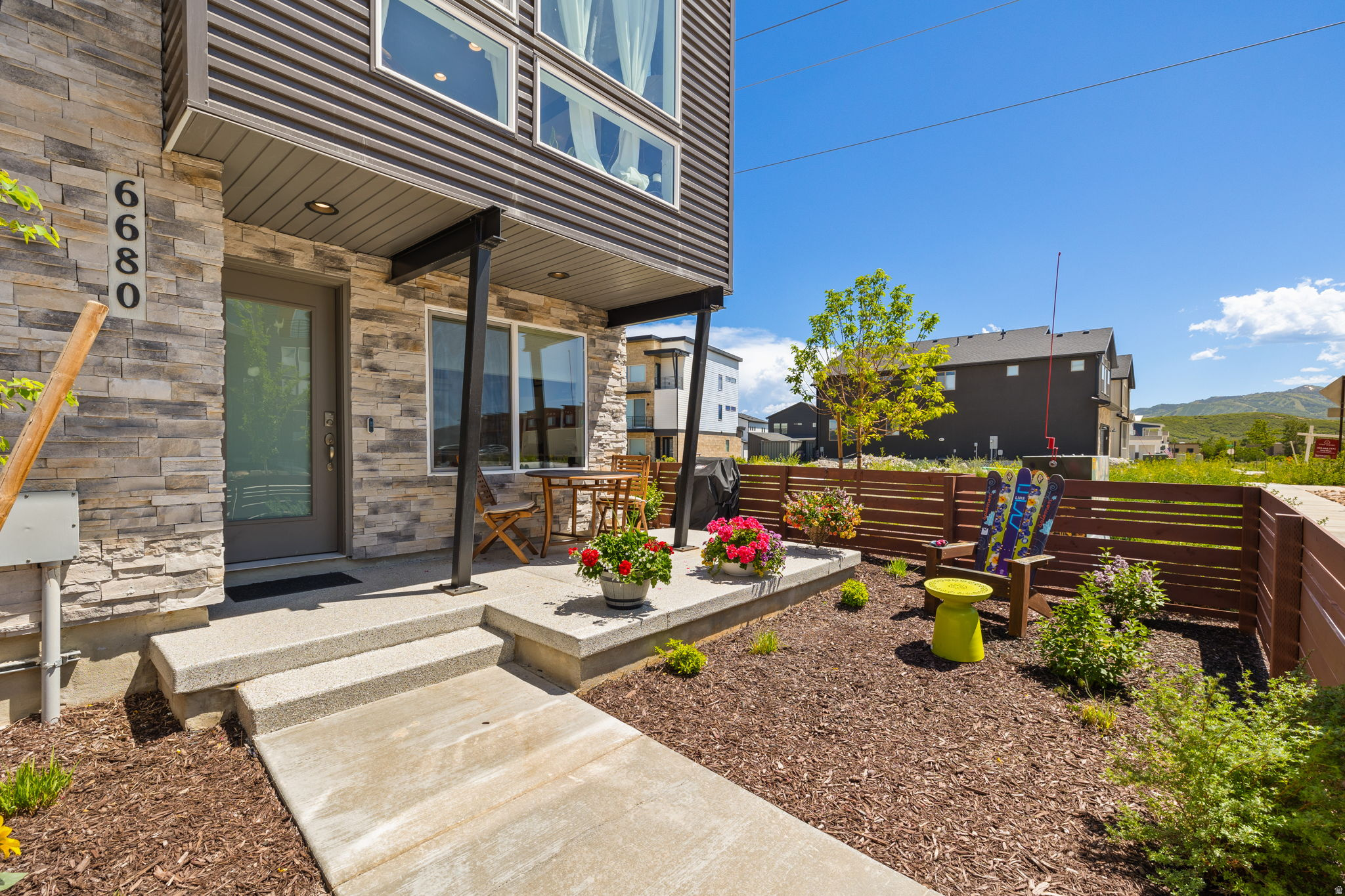 Enjoy mountain views from this spacious, contemporary end-unit townhome in Park City's Silver Creek Village. Offering four bedrooms and three bathrooms, the home is filled with natural light from plentiful windows. The main level features 9-foot ceilings, creating an open, comfortable living space. The kitchen includes a gas range, stainless steel appliances, quartz countertops, and a large island, and opens directly to the family room with a cozy fireplace. Upgrades include custom built-in cabinets and closet systems, along with a smooth wall finish throughout for a clean, modern look. The primary suite includes an ensuite bathroom. Upstairs, you'll find three additional bedrooms, a full bathroom, and a laundry room.  One of the standout features is the rare, fully fenced front yard-ideal for pets, kids, or simply having a private outdoor space, which is hard to find in townhome living. The yard is fully landscaped and includes an expanded coated concrete patio, offering plenty of room to relax, entertain, and take in the views.  The garage is fully finished with epoxy floors, built-in shelving, and a utility sink, providing ample space for vehicles and outdoor gear. The home lives like a single-family residence without the maintenance, as the HOA handles snow removal and yard care. Nightly rentals are approved, offering flexibility for both personal use and investment potential.  Silver Creek amenities include parks, a splash pad, playgrounds, a community garden, and access to cross-country skiing and biking trails. Conveniently located just minutes from Park City Mountain and Deer Valley Resort, with quick access to I-80 for an easy commute to Salt Lake City.