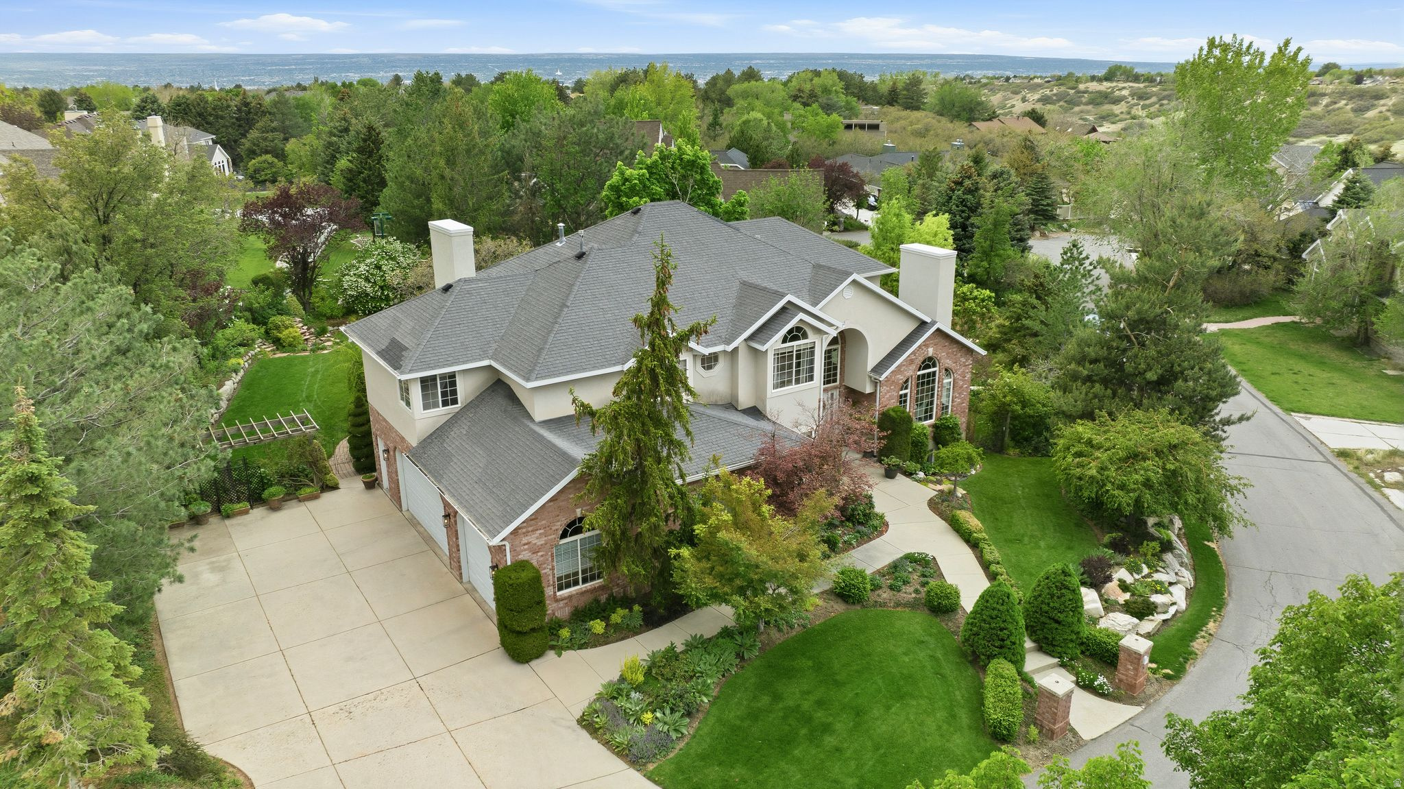 Discover elevated living in the prestigious 24-hour guard gated 477 acres of the Pepperwood community with this exceptional one owner residence at 9 Pepperwood Pointe. Nestled among mature trees, secluded in the park like garden yard, surrounded by nature and mountain views, this home offers a peaceful retreat and access to the unmatched lifestyle Pepperwood is known for. Residents enjoy scenic walking and biking trails, a community pool, life guards, splash pad, spa, competition swim team, sand volleyball, basketball,tennis and pickleball courts, playground, private park, food truck nights and year-round community events, all while being conveniently located near world-class skiing, hiking, shopping, dining, and top-rated schools.   Thoughtfully designed for both comfortable everyday living and effortless entertaining, the property features spacious gathering areas, abundant natural light, and seamless indoor-outdoor living throughout.Exceptionally large primary bed/bath suite with private balcony and large walk-in closet.Retreat to the daylight/walkout lower level with more entertaining gathering spaces, 2 bedrooms, bathroom and plumbing for a sink to start a second optional kitchen.The oversized extra deep and wide garage is exceptional as it can fit 4 cars with plenty of storage.  From the tranquil setting to the incredible community amenities, 9 Pepperwood Pointe presents a rare opportunity to experience luxury living in one of Utah's premier mountain communities. Whether enjoying quiet evenings in the backyard, entertaining guests, or taking advantage of the outdoor lifestyle just outside your door, this property offers the perfect place to call home.Buyer to verify all information.
