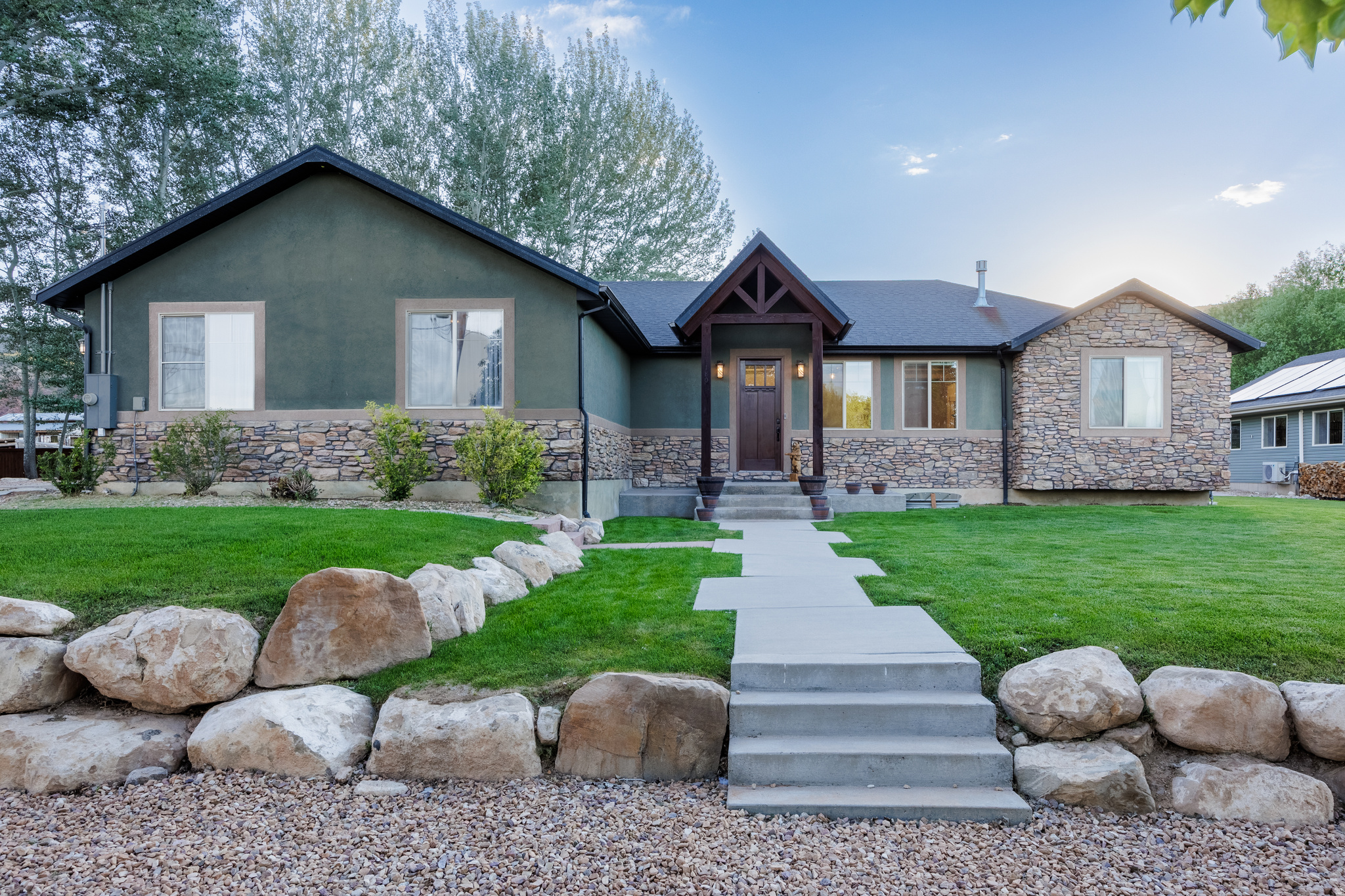 Completely remodeled and packed with upgrades, this one-of-a-kind property offers luxury, flexibility, and endless possibilities. The main home features top-of-the-line cabinetry, flooring, and appliances (sink, appliances and quartz countertops will be installed before closing). Enjoy a walk-in shower, a fun slide to the basement, a home theater with projector, oversized cold storage, and hookups for two washers and dryers on the main floor. All window shades are included, with remote-controlled shades throughout the upstairs and blackout in all bedrooms and in the ADU. Additional upgrades include solar power, a water softener, and an instant water heater.  The basement includes a separate 3-bedroom/1 ba ADU/mother-in-law apartment with its own entrance, playroom, large laundry/craft room, and wood stove.   An additional detached ADU offers an additional 1200 sf of living space with a full kitchen (appliances included), bathroom, laundry, wood stove with fridge, washer and dryer included.  Outside, you'll find a private retreat with a stream, fire pit, swing set, trampoline, salt water hot tub, fenced garden, chicken coop w/electricity, dog run, powered workshop, and two wood sheds stocked with years of firewood. The property also includes full RV hookups with power, water, and sewer dump access, plus a 40-foot shipping container for additional storage and .25 acres the land could be used for horses or livestock if wanted. This rare property offers luxury living, multi-generational flexibility, income potential, and exceptional outdoor amenities all in one.  SEE VIRTUAL TOUR BELOW! Irrigation on the property available with purchase of water shares.  Square footage figures are provided as a courtesy estimate only and were obtained from the county.  Buyer is advised to obtain an independent measurement.