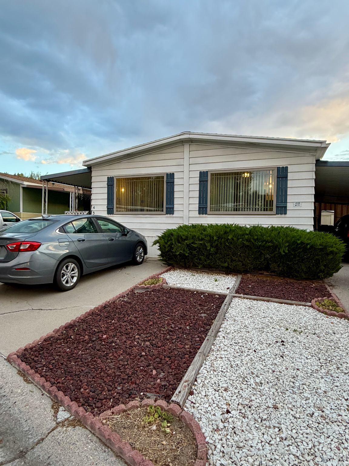 Charming well maintained east facing 3 bed 2 bath manufactured home offering 1104 sq. ft. of comfortable living space. Featuring a functional layout with spacious kitchen and private primary suite with full bathroom. Enjoy relaxing on the front porch for a perfect morning or evening unwinding. Additional highlights include a 2 car tandem carport for convient parking and a 3rd parking spot in front of home. Large storage shed for all your extras. Located in a great area with easy access to local ammenities including shopping, dining, and freeway entrance. Fantastic opportunity for affordable living! Manufactured home is considered chattel and no land is included in the sale. All information is to be verified by buyer and buyer's agent.