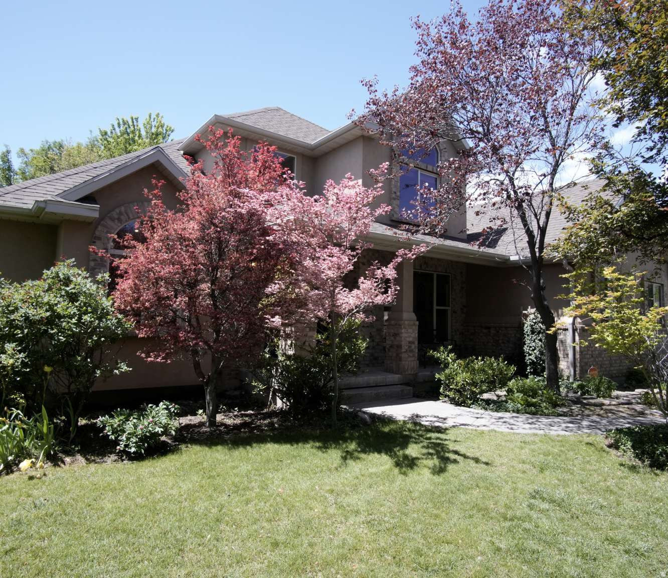 Luxury living meets nature and convenience in this exceptional Highland home, located minutes from I-15 and walking distance of the Murdock Trail and the new Dry Creek Reservoir. Offering 4,136 square feet, this 7-bedroom, 3.5-bathroom home combines warmth, functionality, and a private forest retreat feel. The main floor features 20-foot vaulted ceilings, hardwood floors, new carpet and an updated kitchen with quartz countertops and abundant storage. The spacious primary suite includes a walk-in closet, double sinks and a soaking tub.  The newly finished basement adds incredible versatility with a full second kitchen, workout room, extensive storage and framing for a future walkout!  Outside, mature trees, a large patio, fire pit, and water feature create privacy and natural beauty. This magical yard provides the peace and tranquility of the forest without the canyon drive. A real must see!  Additional highlights include a fenced yard, storage shed, and oversized 3-car garage.