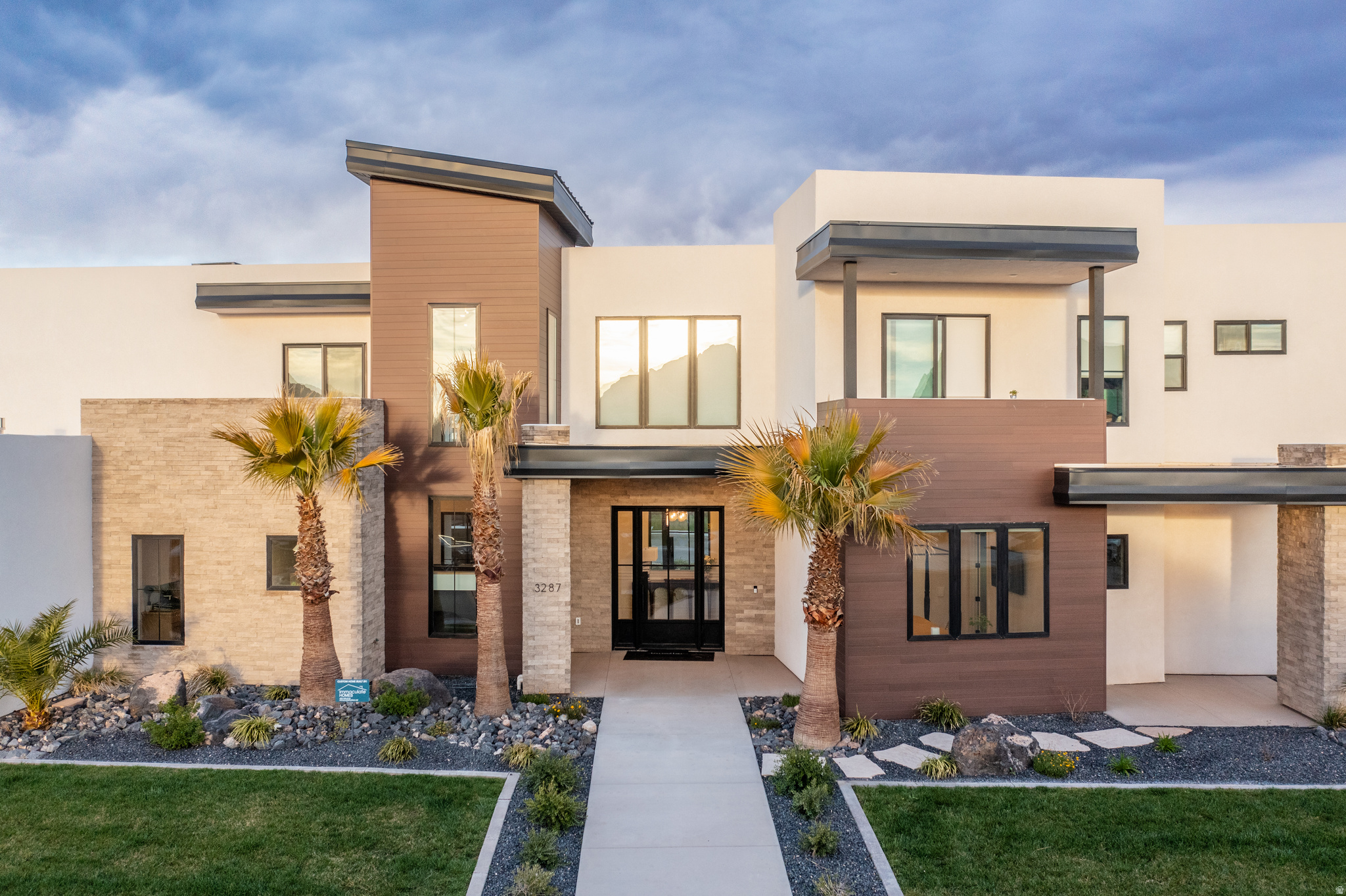 Modern design meets elevated desert living in this stunning 5-bedroom luxury home in St. George, thoughtfully crafted for entertaining and unforgettable gatherings. Clean architectural lines, expansive windows, and striking contemporary finishes create a home that feels both sophisticated and welcoming. The open-concept layout flows effortlessly, allowing indoor and outdoor living to blend seamlessly. Multiple balconies capture breathtaking mountain views, creating the perfect setting for sunrise coffee or unforgettable sunset gatherings. Designed with hosting in mind, the spacious living areas and sleek modern kitchen provide an ideal backdrop for everything from intimate dinners to lively celebrations. Beyond the five beautifully appointed bedrooms, this home offers a truly unique wellness retreat. Tucked discreetly within the home, a hidden yoga room creates a private sanctuary complete with a steam shower and sauna, offering a spa-like experience designed for relaxation, recovery, and balance. A private casita provides incredible flexibility for guests, extended family, or a separate retreat space allowing visitors to enjoy privacy while still being part of the home. Bold architecture. Thoughtful design. Captivating mountain views. Be Bold. Live Beautifully. Welcome Home.