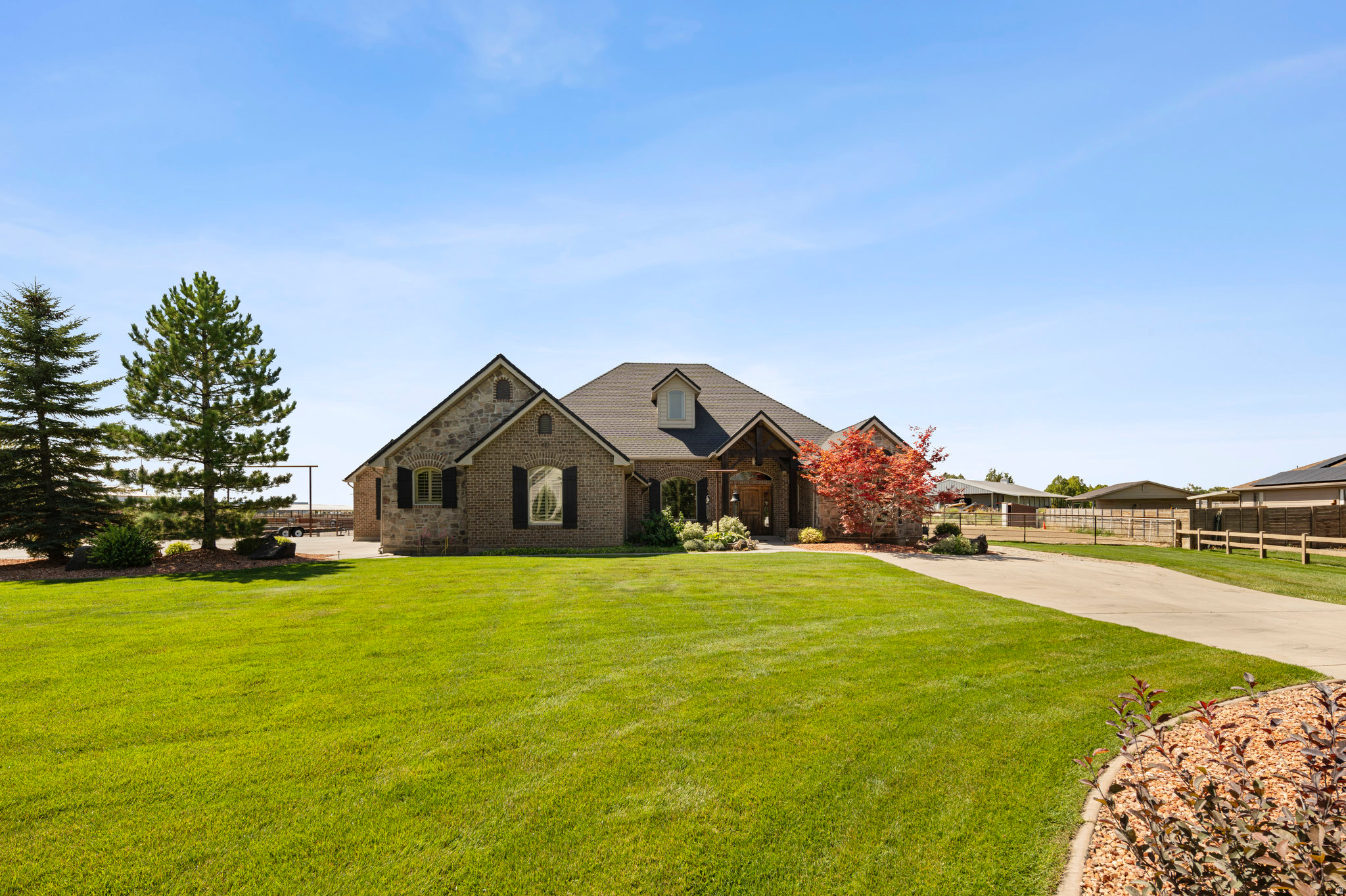 An exceptional custom residence in the prestigious Heritage Ranch community, where refined living meets elevated country elegance.  Expertly designed and built with uncompromising quality, this property offers a rare opportunity to own a truly distinguished estate.  Set on 1.25 acres, the grounds are thoughtfully curated with a premier equestrian setup including turnouts,  riding arena, multiple culinary water spigots, and custom drill pipe fencing and gates.  Two RV dumps are located on the property for those who love to travel. The professionally landscaped property also features covered RV storage/coverall 24 x 45 and an impressive 36 x 52 Cleary shop. This insulated and heated structure includes five overhead doors, three man doors, concrete floors, a finished bathroom, tack room, sitting area, and hot & cold water. 23x65 insulated Horse barn with 4 stalls and individual automatic water units. Inside, the home showcases timeless design and exceptional craftsmanship.  The expansive great room with vaulted ceilings and striking custom rock fireplace creates a warm yet sophisticated gathering space.  The private primary suite offers a luxurious retreat with a spa-like bathroom and generous closet space.  The gourmet kitchen is beautifully appointed with new granite and other alternative countertops, a large island, and custom cabinetry.  Additional features include planation shutters, custom woodwork, a dedicated office/den, bonus room above three car garage, jack& jill bathroom, title flooring, and an expansive covered patio. Constructed with 2x6 exterior framing, a 10/12 pitch roof, and high-efficient HVAC. Fully services with sewer, power, culinary water, and pressurized secondary water, 4 water shares. A property of this caliber is exceptionally rare and nearly impossible to replicate at this price point.  A true legacy property offering space, privacy, and refined county living with modern convenience. This property fits all the boxes!