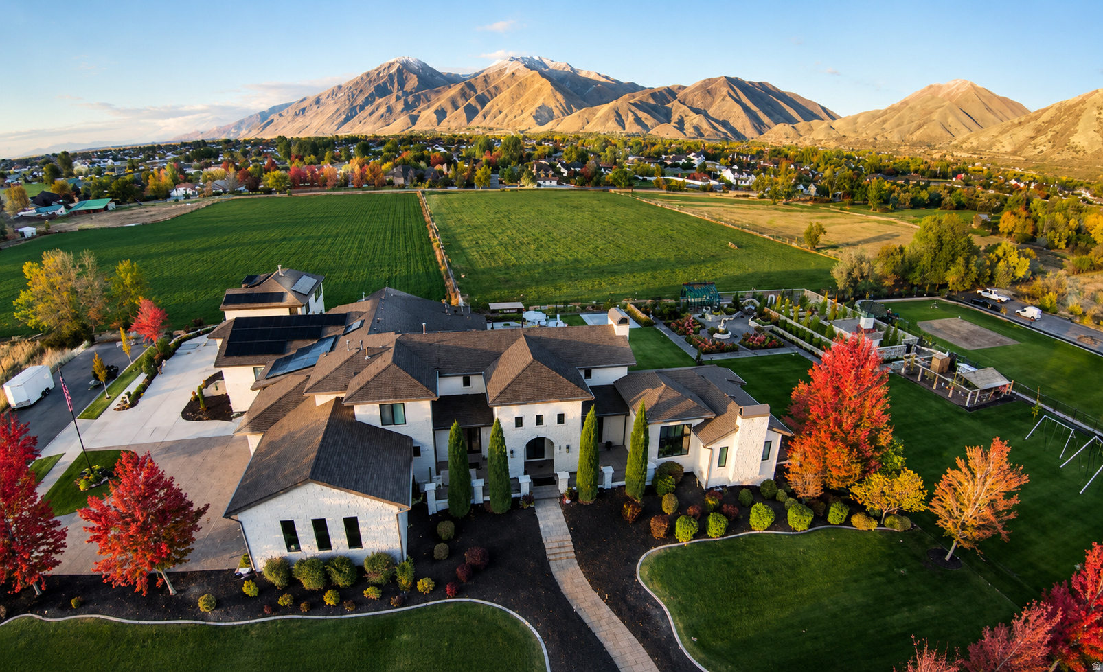 Offered at $5,395,000 and recently appraised at $5,500,000 this estate is priced to sell. This extraordinary Tuscany-inspired estate is perfectly situated in the heart of Mapleton on a rare, fully usable 1.54-acre flat lot, showcasing breathtaking, unobstructed mountain views. Spanning an impressive 12,276 square feet, the home features 6 bedrooms, 6 full bathrooms, and 2 half baths, thoughtfully designed with an incredible layout that balances grand-scale living with everyday comfort. The grounds are fully fenced and beautifully landscaped with mature vegetation, creating a private, resort-style setting highlighted by a stunning gunite heated pool with a diving board and expansive outdoor entertaining spaces including covered patios and hot tub. Just off the pool patio, a basement theater and large gaming area create the perfect space for hosting large gatherings.  The backyard is truly one of a kind, featuring a remarkable atrium-style greenhouse and a fully established vegetable garden that leads to a secluded secret garden stone cottage retreat, complete with a charming structure ideal for art, reading, yoga, or quiet reflection. Additional outdoor amenities include an oversized, top-of-the-line "Max-Air" in-ground trampoline, a life-size chess set for entertaining, and a well-appointed chicken coop, offering a unique blend of luxury and sustainable living.  Inside, the home continues to impress with a indoor basketball and pickleball court, complemented by a spacious workout room that overlooks the pool and surrounding mountain views, creating an inspiring space for recreation and wellness. The property also includes a spacious 7-car garage with two EV charging stations, a newly constructed detached ADU offering 2 bedrooms, 1 bathroom, 982 square feet, and its own private 3-car garage, as well as an additional mother-in-law apartment attached to the main residence.  Designed with both efficiency and security in mind, the home features a new roof, fiber internet, a fully paid-off solar system, a Generac backup generator, and a robust 24 lithium battery storage system. A secure safe room with a Fort Knox door provides added peace of mind, while full home automation, a premium SONOS sound system, and integrated camera systems deliver modern convenience. This is a rare opportunity to own a true legacy estate in one of Utah County's most desirable locations, where luxury, privacy, and lifestyle converge.  Adjacent half acre neighborhood retention lot acts as bonus yard with an orchard, sidewalk for scooters, grass field, and garden beds.  Square footage figures are provided as a courtesy estimate only and were obtained from building plans & appraisal.  Buyer is advised to obtain an independent measurement.