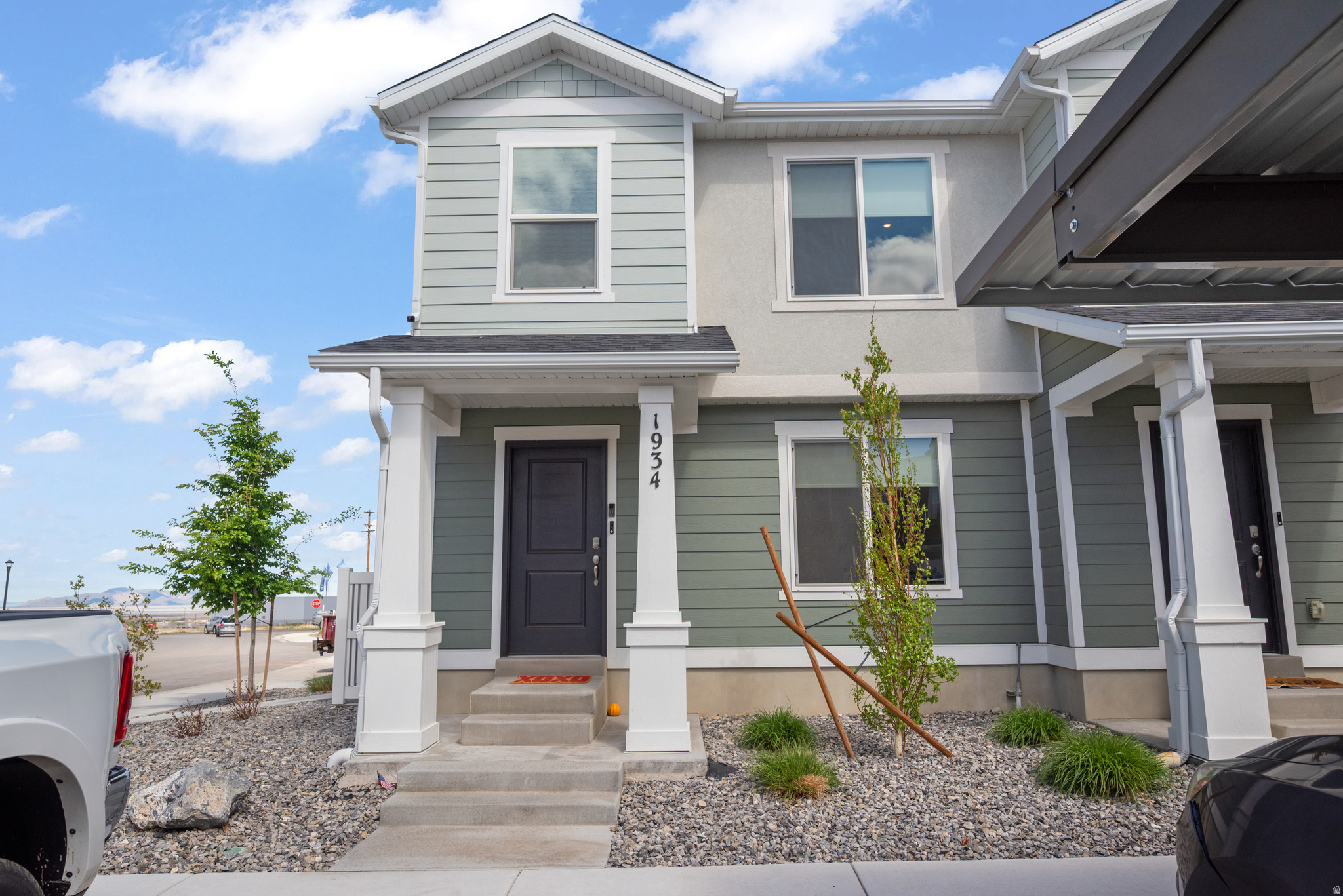 A stunning end-unit townhome built in 2024 and perfectly situated on a desirable corner lot in Tooele's quiet Western Acres neighborhood.  This is ideal for families, first-time buyers, or anyone seeking low-maintenance living with modern comforts. Step inside to an open-concept main level flooded with natural light, where the living room, dining area, and kitchen flow seamlessly together. The home features contemporary finishes throughout and comes move-in ready with thoughtful inclusions: washer, dryer, refrigerator, living room TV, and window blinds - adding instant value and convenience from day one. Outside, enjoy the convenience of a carport with easy access from both front and back, plus a private backyard patio perfect for weekend BBQs, outdoor dining, or unwinding after a long day. The corner lot position gives you extra space and privacy while still being part of a friendly, peaceful community. Whether you're looking for your first home or a smart investment, this turnkey townhome checks all the boxes.