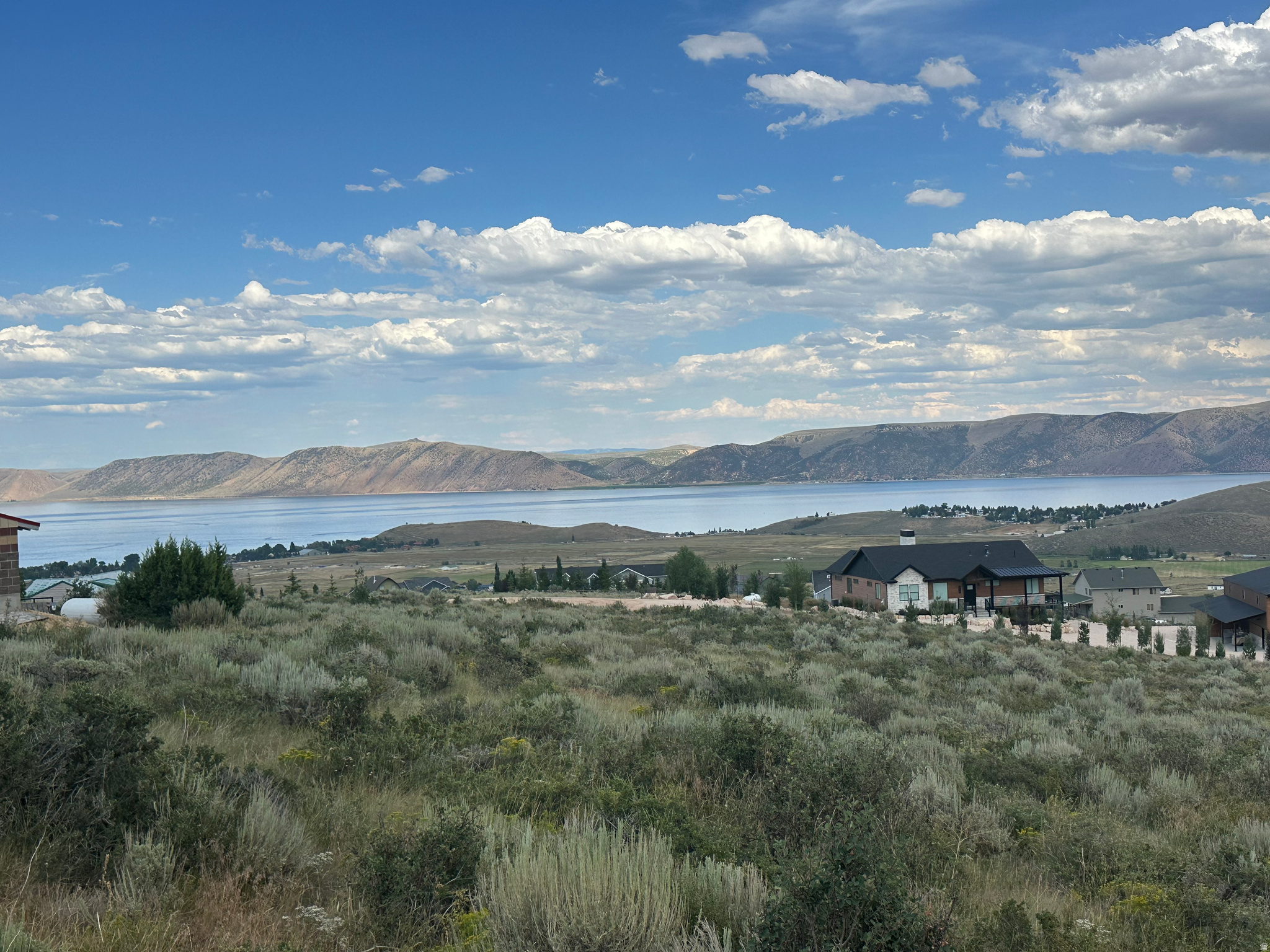 Build your dream mountain retreat on this beautiful 1.16-acre homesite in upper Sweetwater with breathtaking views of Bear Lake. Situated on a gentle downhill slope, the lot offers easy access from the road while preserving protected lake views. Bordering a wildlife corridor, you'll enjoy frequent visits from deer, moose, and other native wildlife. Adventure awaits just minutes away with direct access to the Hodges Canyon Trailhead, connecting you to ATV, UTV, snowmobile, hiking, and biking trails throughout The Sinks and Cache National Forest. Beaver Mountain Ski Resort is only 20 minutes away, while downtown Garden City's restaurants, shops, and famous raspberry shakes are just an 8-minute drive. Owners also have the option to purchase amenities at Ideal Beach Resort, including two heated pools, two hot tubs, multiple sports courts, miniature golf, a beachside playground, expansive grassy areas, and a spectacular sandy beach with boat rentals. Short-term rentals are not permitted, creating a peaceful setting to enjoy all that Bear Lake has to offer.