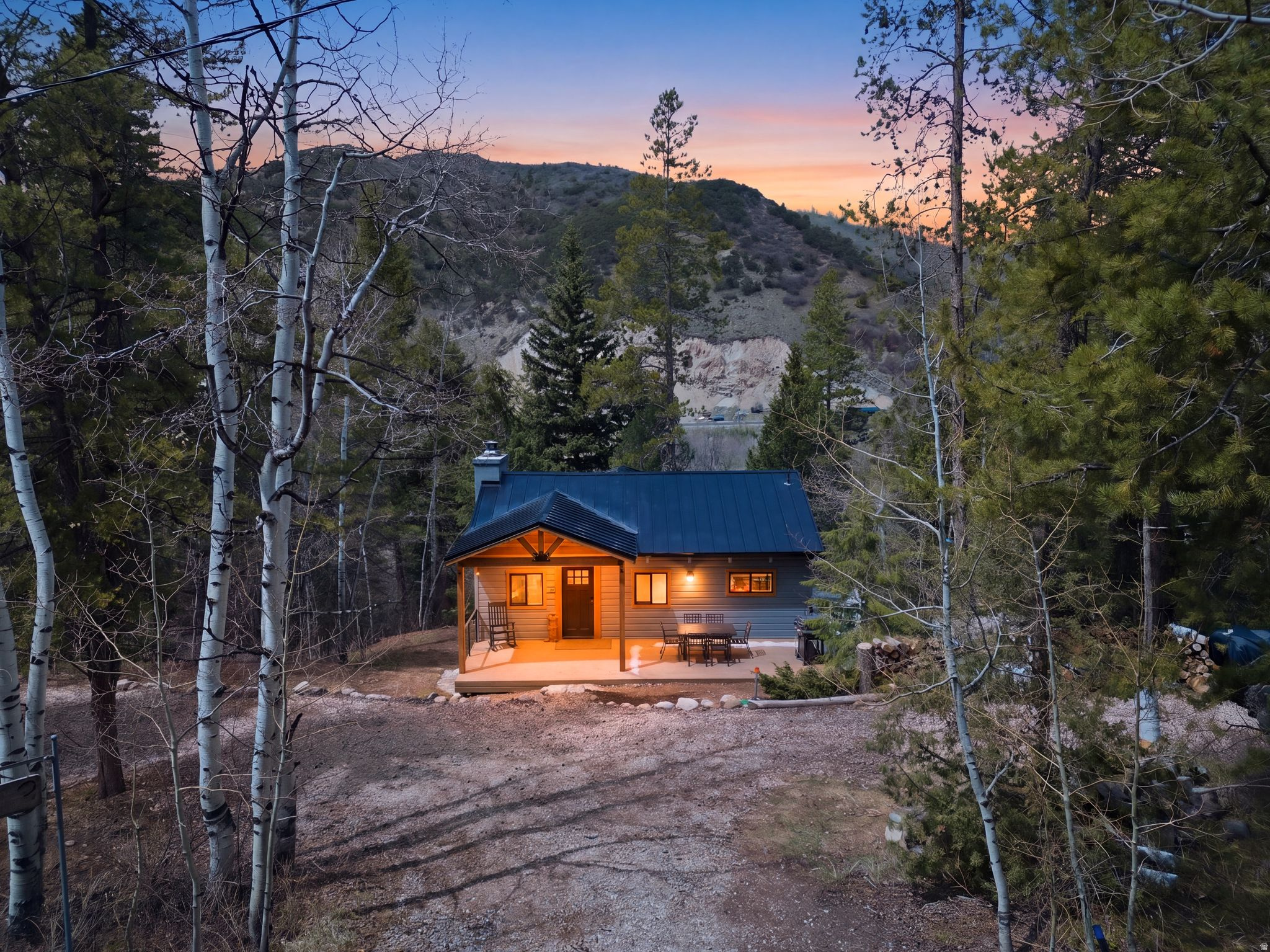 Remodeled Year Round Mountain Retreat in Hidden Lake | River Views & Private Setting  Relax in the privacy and comfort of this beautifully updated retreat within Weber Canyon's Hidden Lake mountain subdivision. Tastefully remodeled between 2022-2024, the home blends modern upgrades with natural beauty and offers a perfect balance of seclusion and accessibility. Featuring a metal roof, durable LVP flooring, efficient mini-split systems, and a wood burning fireplace designed for year-round comfort and enjoyment.  The main level includes two bedrooms, kitchen with breakfast nook, a full bath, plus the kids' favorite loft for additional fun and functional sleeping space, and a welcoming living area centered around a wood-burning fireplace. A lower-level walkout offers a third bedroom, a second living area, wood and coal burning stove, a 3/4 bath and direct access to a covered patio area --ideal for guests or multi-family use.  Surrounded by mature evergreens and aspens, this double lot totals half an acre providing exceptional privacy, along with the soothing sound and peaceful views of the Weber River. Enjoy your morning coffee on the spacious porch out front or unwind in a hammock beneath the trees, immersed in nature.  Hidden Lake residents enjoy private access to a spring-fed mountain lake--perfect for paddle boarding, fishing, or swimming--as well as exclusive Blue-Ribbon fishing on the Weber River. Ideally located just minutes from Smith & Morehouse Reservoir, and Uinta National Forest trails, this property is a true outdoor enthusiast's basecamp or full-time home.