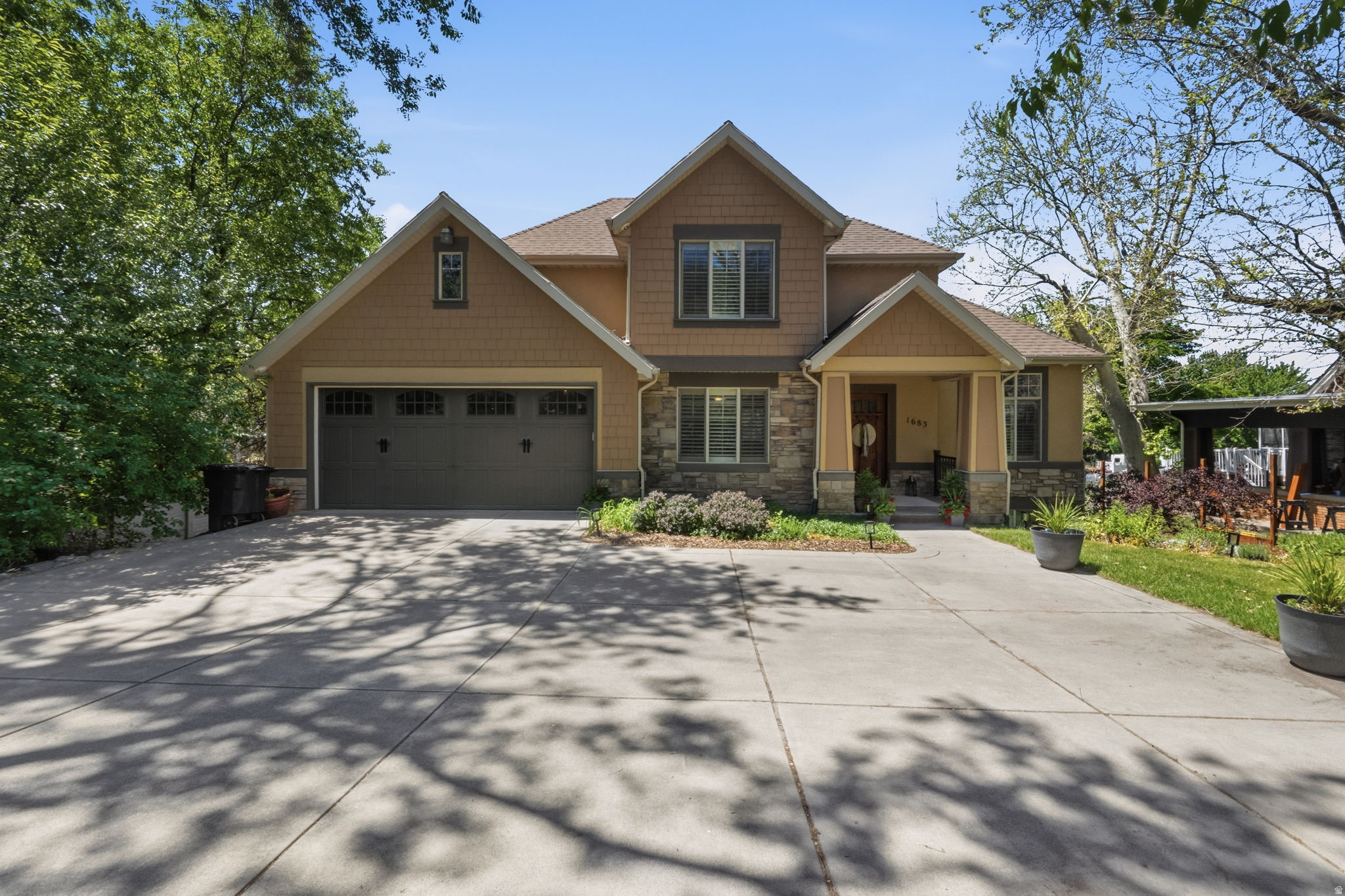 Beautifully designed with comfort, space, and functionality in mind, this impressive 5-bedroom, 3.5-bath home offers 3,640 square feet of thoughtfully planned living space on a generous 0.29-acre lot. Plantation shutters, blinds, and ceiling fans throughout create a warm and inviting atmosphere from the moment you enter. The spacious floor plan provides exceptional flexibility for both everyday living and entertaining. The primary suite serves as a private retreat featuring dual sinks, a relaxing jetted tub, separate shower, and private water closet designed for comfort and convenience. A full daylight walkout basement adds even more versatility with direct access to a covered patio, creating seamless indoor-outdoor living ideal for gatherings, recreation, or quiet evenings at home. Outdoor living continues with a large covered deck perfect for entertaining or enjoying peaceful mornings and evenings year-round. Storage is a standout feature throughout the home, including a suspended garage with an expansive storage area and convenient exterior double-door access ideal for tools, hobbies, seasonal dcor, or recreational equipment. Two water heaters installed in 2022 add efficiency and everyday convenience to this thoughtfully designed home.   Square footage figures are provided as a courtesy estimate only and were obtained from county records.  Buyer is advised to obtain an independent measurement.