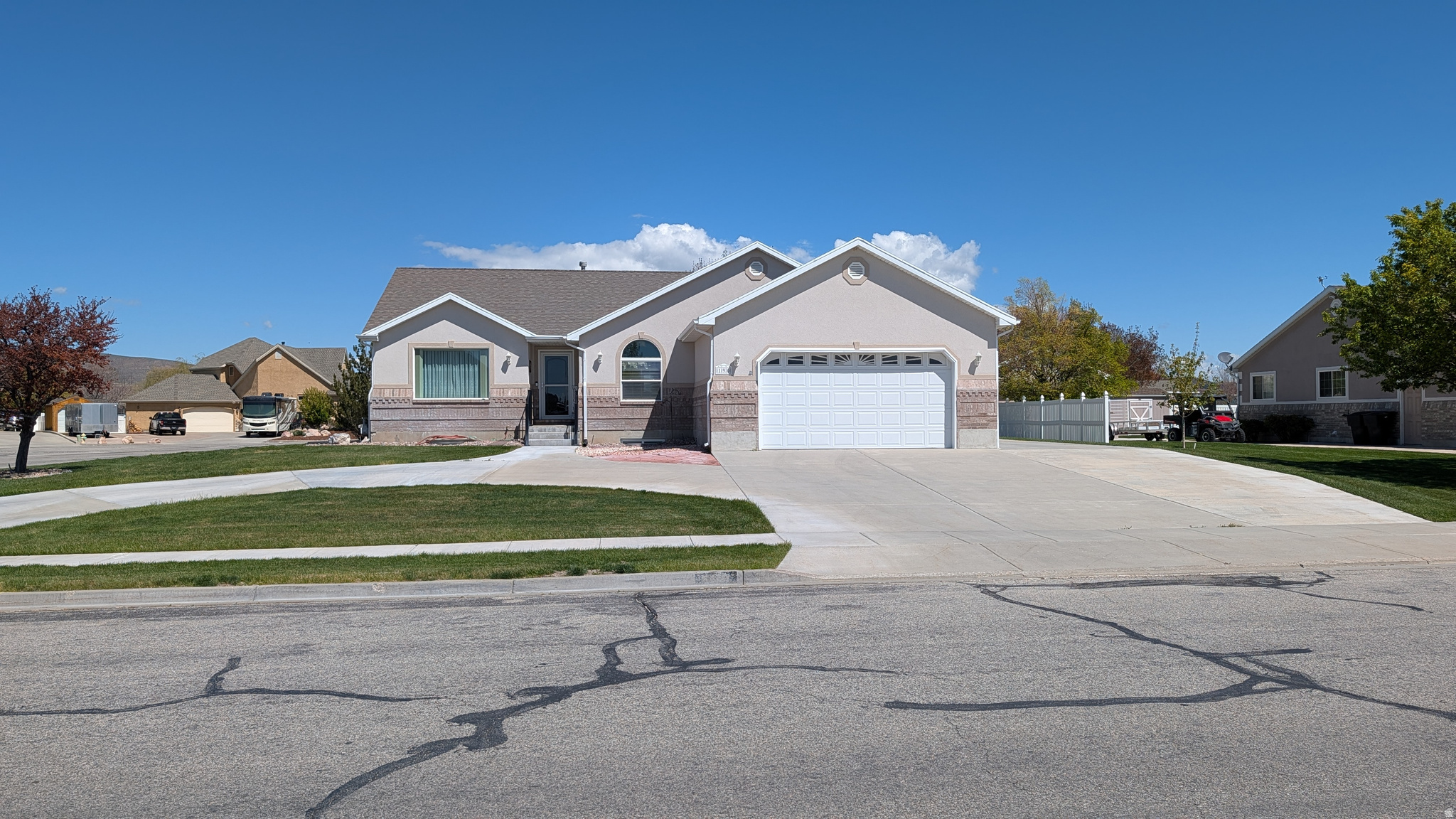 Beautiful rambler with comfortable main-level living and room to grow! Well maintained by original owners and near downtown Tremonton. The open great room features vaulted ceilings, creating a bright and spacious atmosphere perfect for gathering and entertaining. The kitchen includes a cooktop built into the island, separate wall oven, and plenty of counter space and storage. The spacious primary suite includes a walk-in closet and a luxurious en-suite bath with dual sinks, a large jetted tub, and separate shower. Enjoy outdoor living on the covered back patio overlooking the large backyard. Additional features include a pull-through driveway and oversized RV parking pad. The partially finished basement includes a bedroom and small family room, with ample space to add more. Framing and drywall materials to help complete the basement are already included and stored onsite. This home offers the perfect combination of comfortable country living, functional space, and future potential!