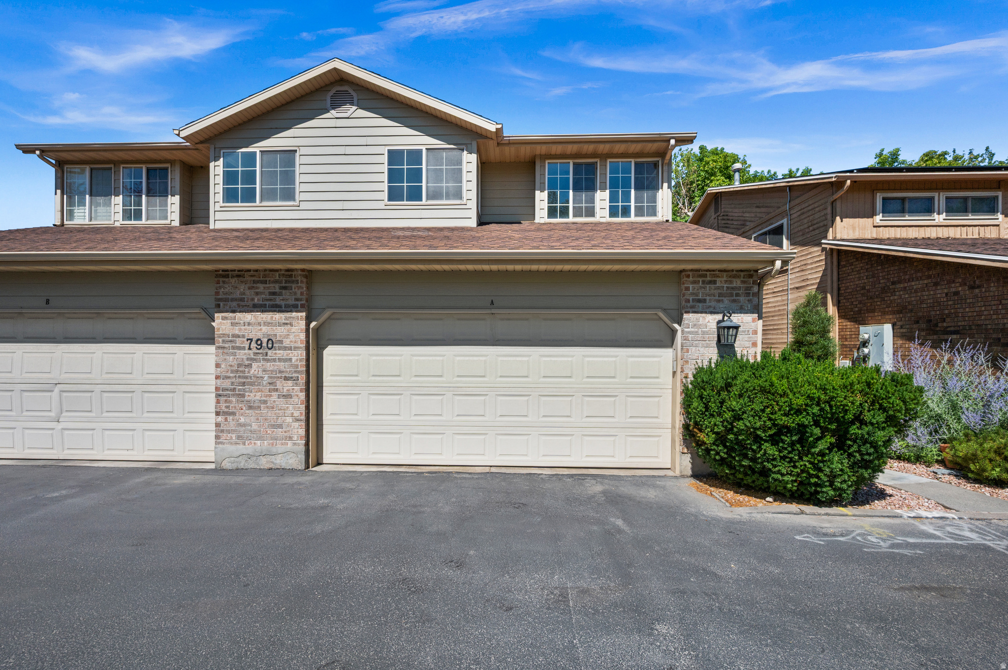 Cozy updated townhome, in Millcreek in a  a quiet secluded neighborhood. This 3 bedroom, 2.5 bath in Scottbrook is part of a 20 unit complex, next to a park.  On the main floor the unit features an open floor plan, kitchen, an inviting living room with a gas fireplace, a door that opens out onto a deck that overlooks the central green space for the complex. The primary suite includes a primary bathroom with a  tub and separate tile shower and  a large closet. There is an attached two car garage. New carpeting and paint through out. HVAC was replaced in 2025. This centrally located condo close to shopping, dining and major freeways is a rare find for the price, the perfect blend of comfort , charm and affordability. Don't miss this one!