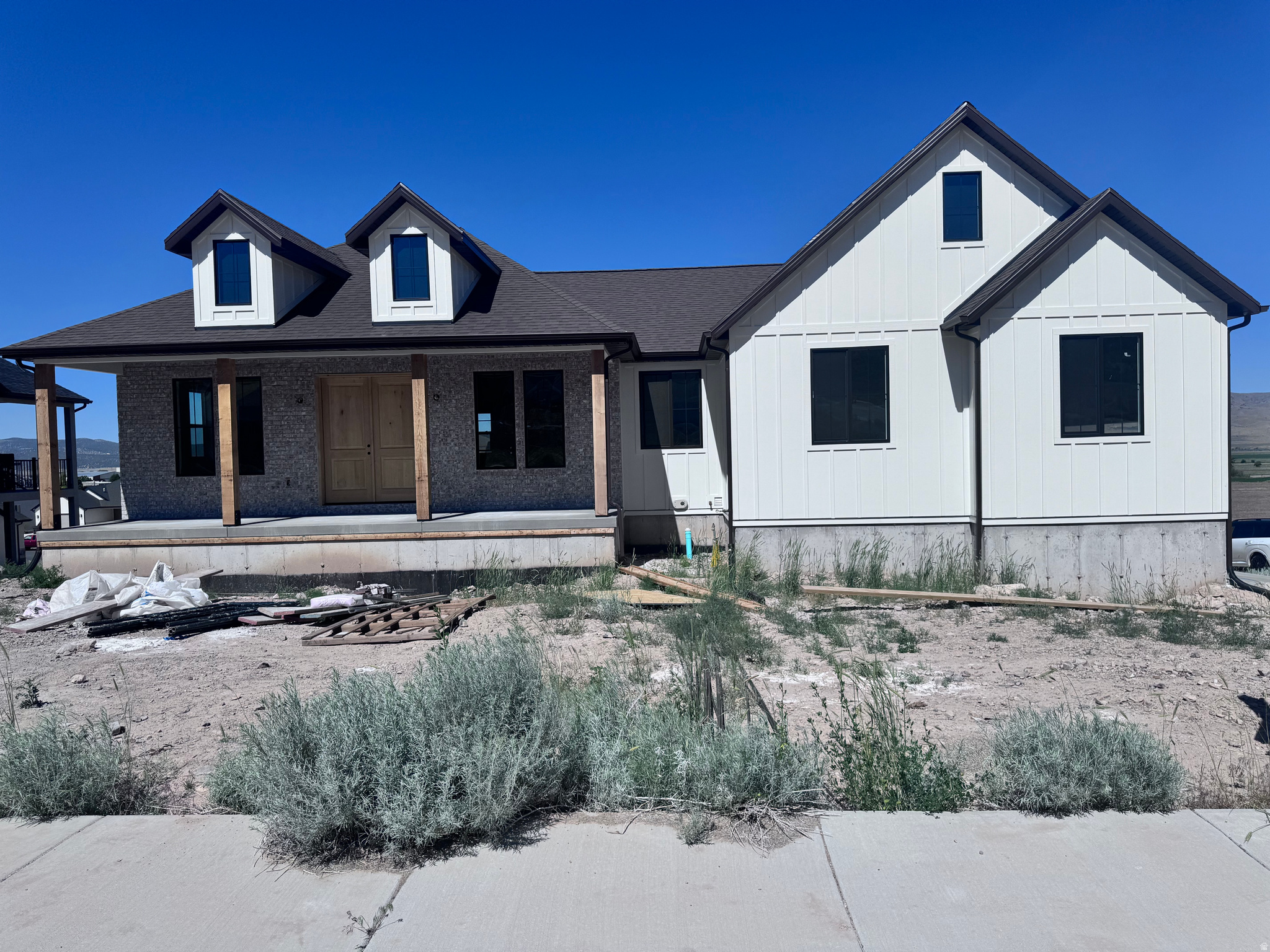 Beautiful modern farmhouse on a desirable corner lot offering 3 bedrooms, 2 bathrooms, and 3,300 sq ft of thoughtfully designed living space. Built by a proven builder known for quality craftsmanship and attention to detail. Open-concept floor plan with abundant natural light and stylish finishes throughout. The kitchen features custom cabinetry, quartz countertops, and all appliances included. Spacious living and dining areas provide an ideal layout for everyday living and entertaining. Primary suite offers comfort and functionality, while additional bedrooms provide flexibility for family, guests, or office space. Enjoy outdoor living with a covered deck off the main level and a covered patio at the walkout basement. The unfinished walkout basement allows for future expansion to suit your needs. Additional highlights include a tankless on-demand water heater. Estimated completion date: June 1, 2026.