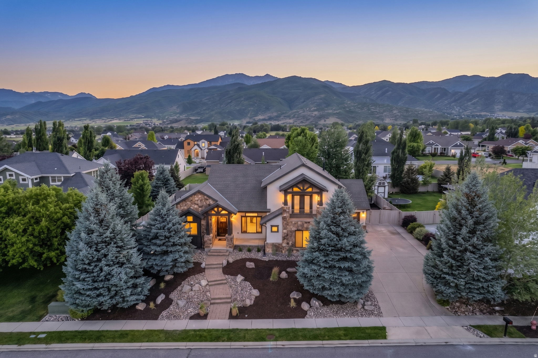 Welcome home to Midway! Perfectly positioned to capture mountain views in all directions,  this stunning custom home blends high-end updates with everyday livability.  The main level is an entertainer's dream, featuring a wide-open floor plan that flows seamlessly into a recently updated, chef-ready kitchen complete with new countertops and backsplash, a built in fridge and top tier appliances.  Step outside to find a beautifully landscaped, meticulously maintained yard that serves as your private mountain oasis.  When it's time to unwind, the grand master suite is a true sanctuary. Boasting soaring ceilings, a massive spa-like bathroom, and generous his-and-hers closets, it's the perfect place to recharge.  The lower level is purpose-built for family life and wellness. Let the kids take over the dedicated downstairs hangout area while you hit your private home gym-complete with a sauna to thaw out after a long day on the slopes. Top it all off with a massive, oversized 3-car garage with plenty of room for your vehicles, bikes, and outdoor gear.  Beyond the property lines, the location is unbeatable. You are just minutes from the artisan bakeries and restaurants of charming downtown Midway, and only a quick, scenic drive to world-class skiing at the new Deer Valley East Village. This isn't just a home; it's the mountain lifestyle at its absolute best.