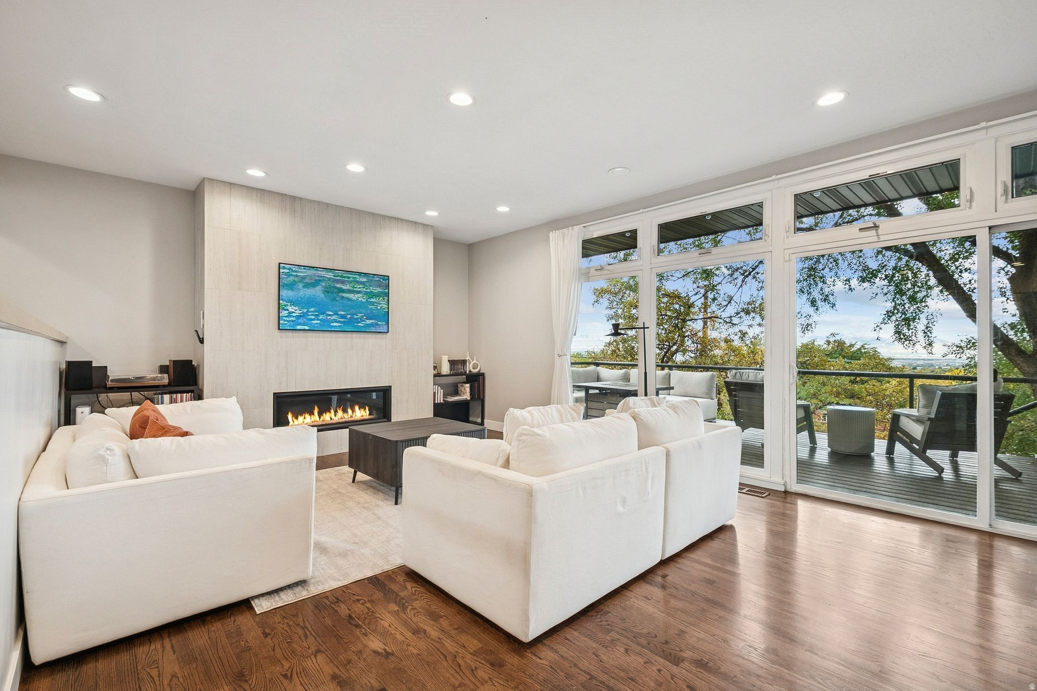 Tucked into one of Salt Lake City's most desirable east-side foothills neighborhoods, this fully remodeled 1957 rambler delivers effortless main-level living with the views to match. The open great room flows to a covered patio and secluded backyard where the Wasatch and valley panoramas take center stage - morning or evening, it never gets old.  The thoughtfully updated interior features hardwood floors, a primary suite with walk-in closet and separate tub/shower, and a fully finished walkout basement with a second kitchen and mother-in-law apartment - ideal for multi-generational living or rental income.  A fully landscaped, fenced yard with mature trees, smart thermostat, attached garage, and quick freeway access round out a home that checks every box.