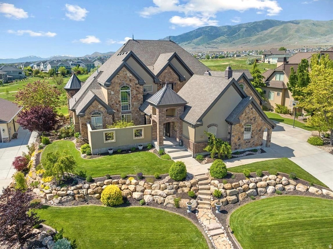 Updated ultra-custom masterpiece, located in a private lakeside resort community, backing Talon's Cove Golf Course with views of Mount Timpanogos, Utah Lake and one of the most scenic fairways in Utah. Prime location, timeless design, and quality craftsmanship with attention to every detail make this one of Saratoga's finest and most uniquely impressive homes, which must be seen in person to fully appreciate. The main level is ideal for gatherings with a grand entry, extensive great room with soaring windows and ceilings, gourmet kitchen with a butler's pantry, and formal dining. The main-level primary suite extends into the southeast tower, providing a sanctuary space with panoramic views, and includes a spa-like bathroom, and an expansive closet with built in shoe racks, drawers and an island, along with secondary laundry hookups. Additional main-floor highlights include a two-story executive office/den/library with floor-to-ceiling windows, built-in workspace and bookshelves, and coffered ceilings; a mud room area with abundant cabinetry for storage.; and an extensive laundry room with flex space for crafts, projects, home business or other use. The daylight basement is a wonderland for all ages. Children (or the young-at-heart) might prefer to skip the stairs and access the basement by taking a concealed slide from Rapunzel's Tower to Cinderella's Castle on the way to Snow White's Cottage, and passing by the Beast's Den before exiting into a vintage English street setting (Harry Potter themed occasionally) with a parlor leading to a luxury theater including stadium seating and Dolby Atmos surround sound for a true cinematic experience. Other basement features include a massive family room with space for a wide variety of recreational activities; a corner tower room with panoramic windows, a guest bedroom and bathroom suite; a large additional bedroom or workout area; abundant storage spaces, and a walkout exit with French doors. The upstairs level features two bedrooms with full ensuite bathrooms, a spacious additional bedroom/bonus room above the garage, a large loft with access to the covered deck and a secret lounge accessible through a built-in bedroom bookshelf. The corner firepole (with restricted access) will get you from upstairs to the main level quickly in the event of a fire (or if you are just running late for dinner). Exterior features include a private inner courtyard with a garden, waterfall, and full-size gas or wood burning brick fireplace; a covered deck and patio with postcard-worthy views; customizable landscape lighting to accentuate the beautiful and mature landscaping; in-ground trampoline; 43 solar panels, providing abundant clean electricity at a nominal cost; spacious 4-car garage spanning over 1,000 sf.; RV / boat parking, etc. Comfort and livability features include radiant floor heat in select tile areas, reverse osmosis water system, instant hot water, integrated humidifier, whole home intercom system, soundproofing, and four bedrooms with full ensuite bathrooms. Experience the incredible lifestyle this home and community provide. Unique and extensive HOA amenities include a private boat marina; multiple lakefront clubhouses with exercise facilities, game rooms, swimming pools and spas, including a one-of-a-kind year-round natural hot-springs pool & spas; multiple parks, including a lakeside park with a stream, beach volleyball, playground, large pavilion with an outdoor fireplace; scenic walking trails along Utah Lake, etc. This remarkably serene atmosphere is only minutes away from extensive restaurants, shopping and other conveniences. New roof installed in 2025. Two new 50-gallon water heaters installed in 2026. Home warranty included with sale. To view a video tour and a point/click 3D property tour click "View Tours" on the listing, or visit: https://my.matterport.com/show/?m=1m8i9zUQHD8 (for a 3D tour) or https://vimeo.com/964750567?share=copy (for a Video Tour). Note - portions of home
