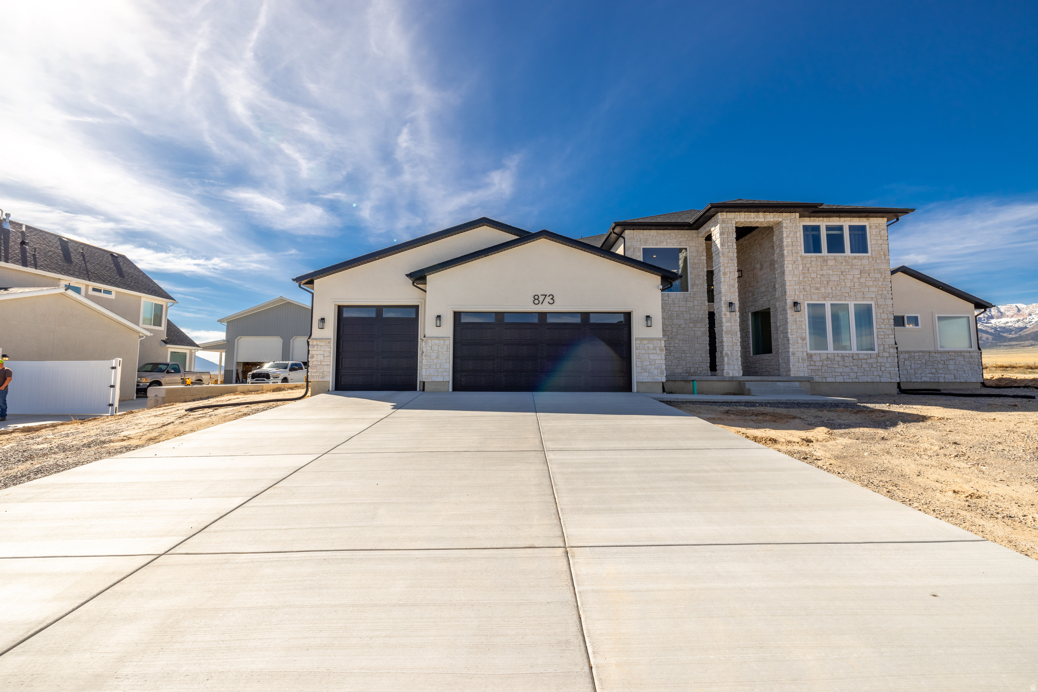 Beautiful 4-bed, 2.5-bath home on a spacious .51-acre lot in Granstville, UT. Bright, open floor plan with plenty of natural light, generous bedrooms, and modern finishes throughout. Enjoy wide-open, panoramic views and outdoor space perfect for gardening, entertaining, or relaxing. Third car garage door is 9'x9'  Extra garage/shop has a 14'x14' garage door opening and dimensions are 21'x36'x16' tall perfect to store your RV. The extra garage is 70 percent complete and is  perfect for someone who likes having a project to complete. This home offers nice rural living with country feel without having to go too far-your peaceful retreat awaits.