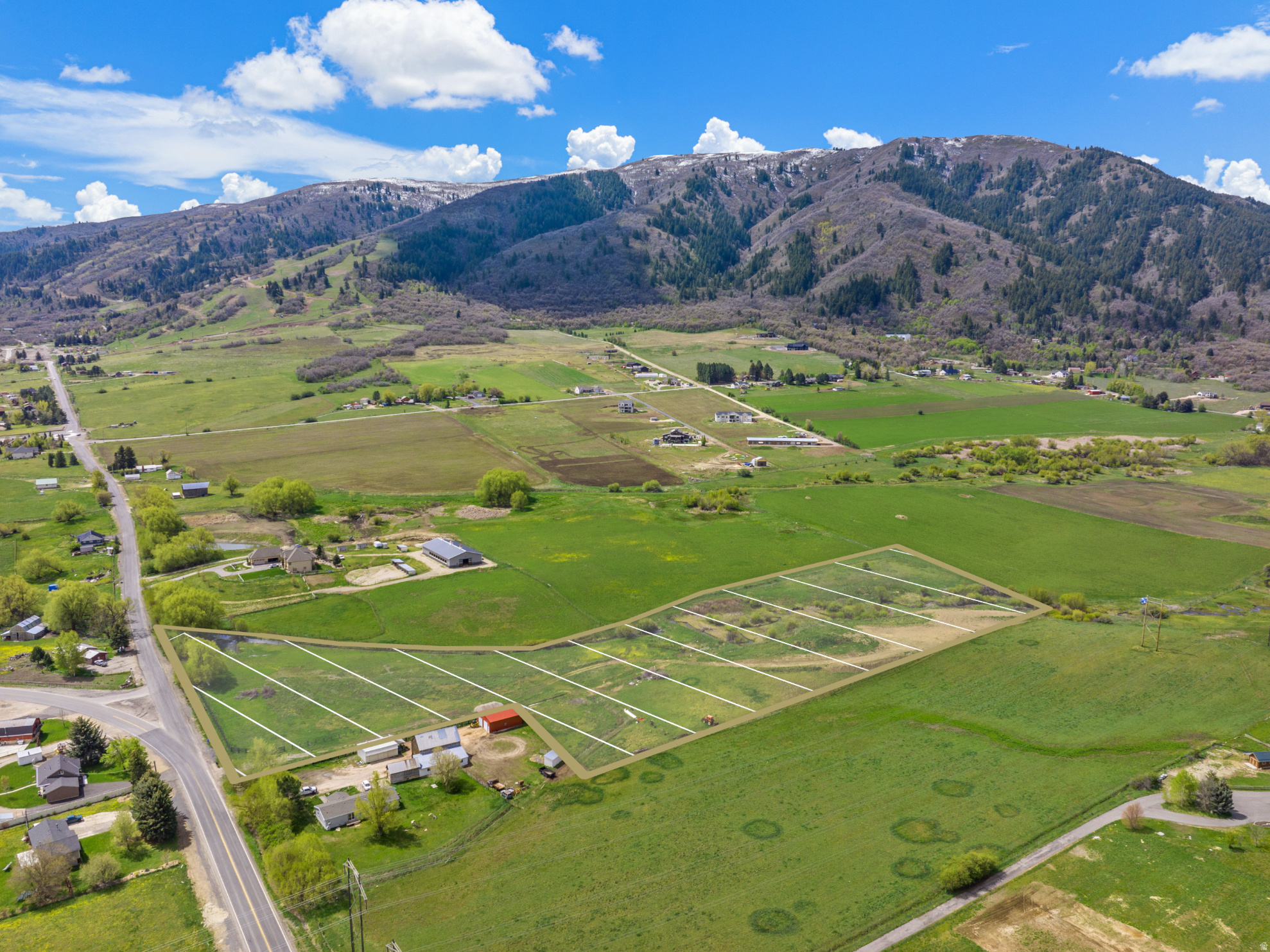 Rare 10+ acre legacy parcel in Liberty, Utah with breathtaking panoramic views of the Wasatch Mountains and Ogden Valley. A year-round spring-fed stream winds through the property, creating a peaceful, serene setting alongside a secluded wildlife-rich riparian area where deer, birds, fish, and an occasional beaver are regularly enjoyed. The property includes 4.7 acres of deeded irrigation water rights with an 1861 priority-an increasingly rare and highly desirable asset offering reliability and control beyond typical water shares. With lush pasture, privacy, and a well capable of servicing two homes, this property is perfectly suited for a luxury estate, equestrian use, or mountain retreat. Just minutes from world-class skiing at Powder Mountain and Snowbasin, and close to Pineview Reservoir for four-season recreation. *All property information, boundaries and documents to be verified by buyer.