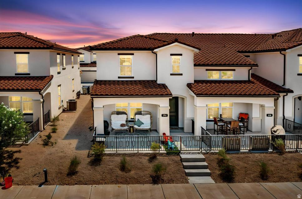 This beautiful home showcases a bright, open-concept floor plan with designer finishes and thoughtful upgrades throughout, including upgraded appliances, lighting, range hood, iron railing, ceiling fans in every room and on the patio, plus plumbing already in place for a pot filler. The gourmet kitchen features granite countertops, stainless steel appliances, a spacious walk-in pantry, and an island that flows seamlessly into the living and dining areas. Upstairs, the primary en-suite offers a generous walk-in closet with an extra loft space nearby. Relax on the private covered patio, enjoy the community clubhouse that is in close proximity and enjoy everything this award-winning community has to offer. Such as, the 2.5-acre lagoon, 3 pools, multiple hot tubs, parks, pickleball courts, trails, and year-round community events. Conveniently located near Freedom Prep Academy and just minutes from Smith's, Costco, dining, and exciting future development, including a new city park.