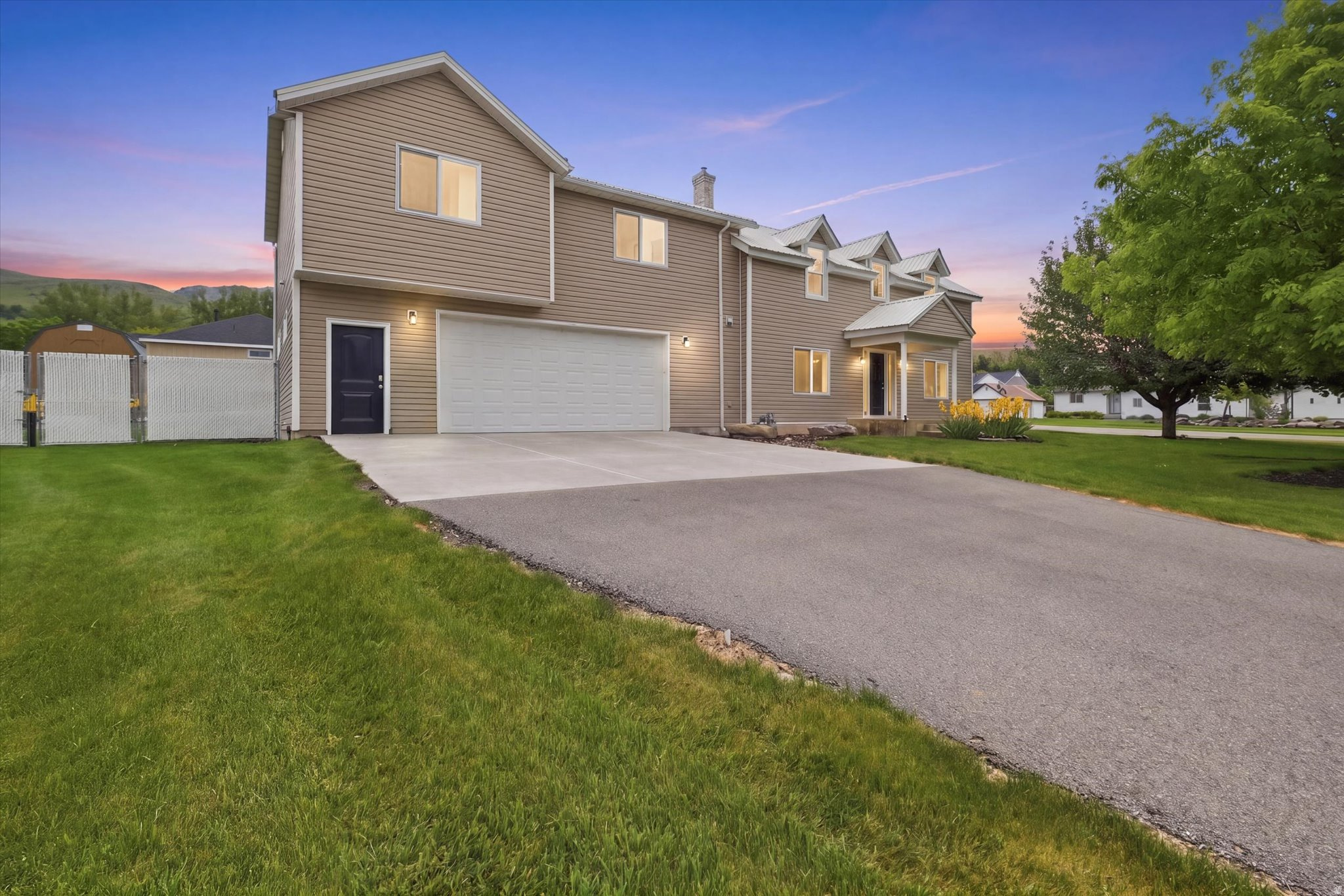 Completely remodeled home in a desirable East Bench Richmond location with beautiful mountain views from the large deck. Originally built in 1900, the home underwent a significant addition and renovation in 2013, which added approximately half of the current living space, blending historic charm with modern amenities. Features include new paint, carpet, furnace, tankless water heater, and automatic roller shades.  The bright kitchen offers white cabinetry, a large island, and upgraded Thermador appliances. Enjoy a main-floor bedroom and laundry, plus four additional bedrooms and a spacious family room upstairs. Outside you'll find a fenced yard, oversized garage, outbuilding, and a heated workshop with a new mini-split system. A well-updated home with plenty of space, storage, and functionality in a great location.  Explore the Full Virtual Tour of 195 S 200 E to preview the large deck with mountain views, bright Thermador kitchen, upstairs family room, oversized garage, outbuilding, and heated workshop before your private showing.