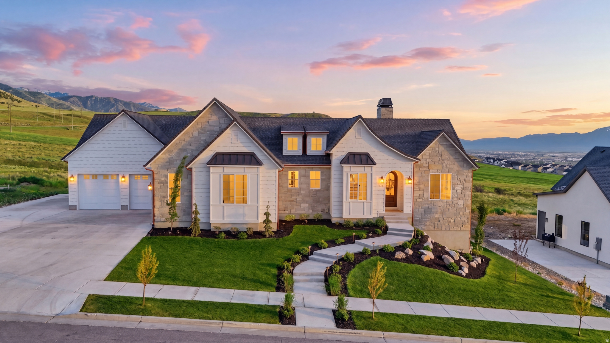 Designed with exceptional attention to detail and built for both luxury and functionality, this stunning custom home on the Smithfield bench offers elevated finishes, thoughtful design, and breathtaking mountain and valley views throughout. From the moment you step inside, the expansive 10' ceilings and vaulted great room on the main level, wide 48" staircase, and engineered hardwood flooring create an impressive sense of scale and sophistication.  At the heart of the home, the chef's kitchen showcases floor-to-ceiling custom cabinetry, an oversized island, marble countertops and backsplash complete with pot filler. The adjoining butler's pantry and custom mudroom continue the seamless cabinetry and high-end design, creating both beauty and practicality for everyday living and entertaining.   A Trex deck off the main level extends the living space outdoors to enjoy the incredible surrounding views.  The private primary suite offers a true retreat with vaulted ceilings, a cozy fireplace, and a spa-inspired ensuite featuring dual vanities, marble countertops, a marble tile shower, soaker tub, and polished nickel fixtures. Additional upscale finishes include marble countertops in the pantry, half bath, and laundry room, marble tile flooring in the laundry and additional bathroom, granite countertops in the upstairs full bath, and quartzite countertops with marble tile in the basement bath.  The fully finished walk-out basement was designed with entertaining and comfort in mind, featuring 9' ceilings, a custom built-in entertainment center, built-in desk, wet bar, theatre room, dedicated workout room, and direct access to the covered patio.  Additional premium upgrades inside include a tankless water heater, whole-home humidifier, and extensive sound insulation throughout the main floor and interior walls for enhanced privacy and quiet living.  Exterior upgrades include natural stone, including the chimney with topper, gas lanterns, hardwired landscape lighting and extended life composite shingles.  The oversized heated and insulated 4-car garage is a standout feature, offering epoxy flooring, extra height clearance, 9' high-lift garage doors, attic storage above the garage, and a rare 32' deep east-side bay ideal for oversized vehicles, boats, trailers, or recreational toys. Additional conveniences include exterior generator hookup and a 50-amp RV/trailer plug.  Fully landscaped and perfectly positioned to capture sweeping mountain and valley views, this remarkable home blends timeless luxury, thoughtful craftsmanship, and everyday livability into one exceptional property.  Square footage figures are provided as a courtesy estimate only and were obtained from builder .  Buyer is advised to obtain an independent measurement.