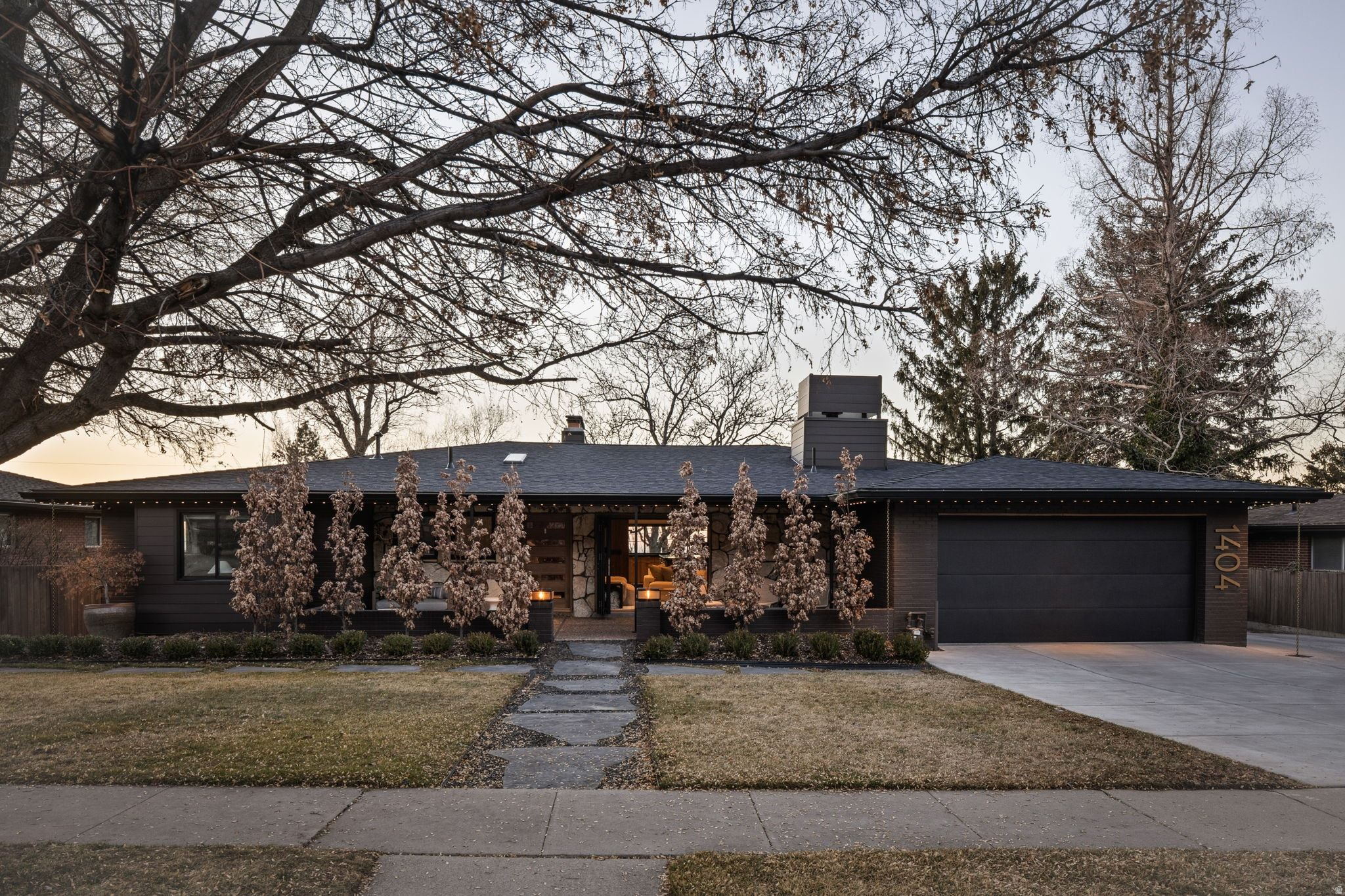 Completely reimagined in 2024, this East Bench residence was taken down to the studs and rebuilt with intention, quality, and timeless design at the forefront.  Located in one of Salt Lake City's most established neighborhoods, 1404 Canterbury blends elevated craftsmanship with modern functionality. The heart of the home features a stunning chef's kitchen with custom cabinetry, natural stone surfaces, and high-end integrated appliances, designed for both everyday living and effortless entertaining. Clean architectural lines, warm wood tones, and curated lighting create a refined yet inviting atmosphere throughout.  The open-concept living spaces flow seamlessly to private outdoor areas, including a covered patio with fire feature, perfect for Utah evenings. Thoughtful design details continue into the primary suite and spa-inspired baths, where boutique-level finishes, soaking tub and steam shower, and custom tilework offer a true retreat experience.  Every system has been updated, including custom LED lighting, integrated Sonos audio throughout, electric blinds, and a whole-home water filtration system, bringing modern convenience without sacrificing aesthetic integrity.  Set just minutes from the University of Utah, downtown Salt Lake, and quick canyon access to Park City and world-class skiing, this home offers both elevation and accessibility.  1404 Canterbury Drive is not simply renovated-it is rebuilt, refined, and ready for its next chapter.