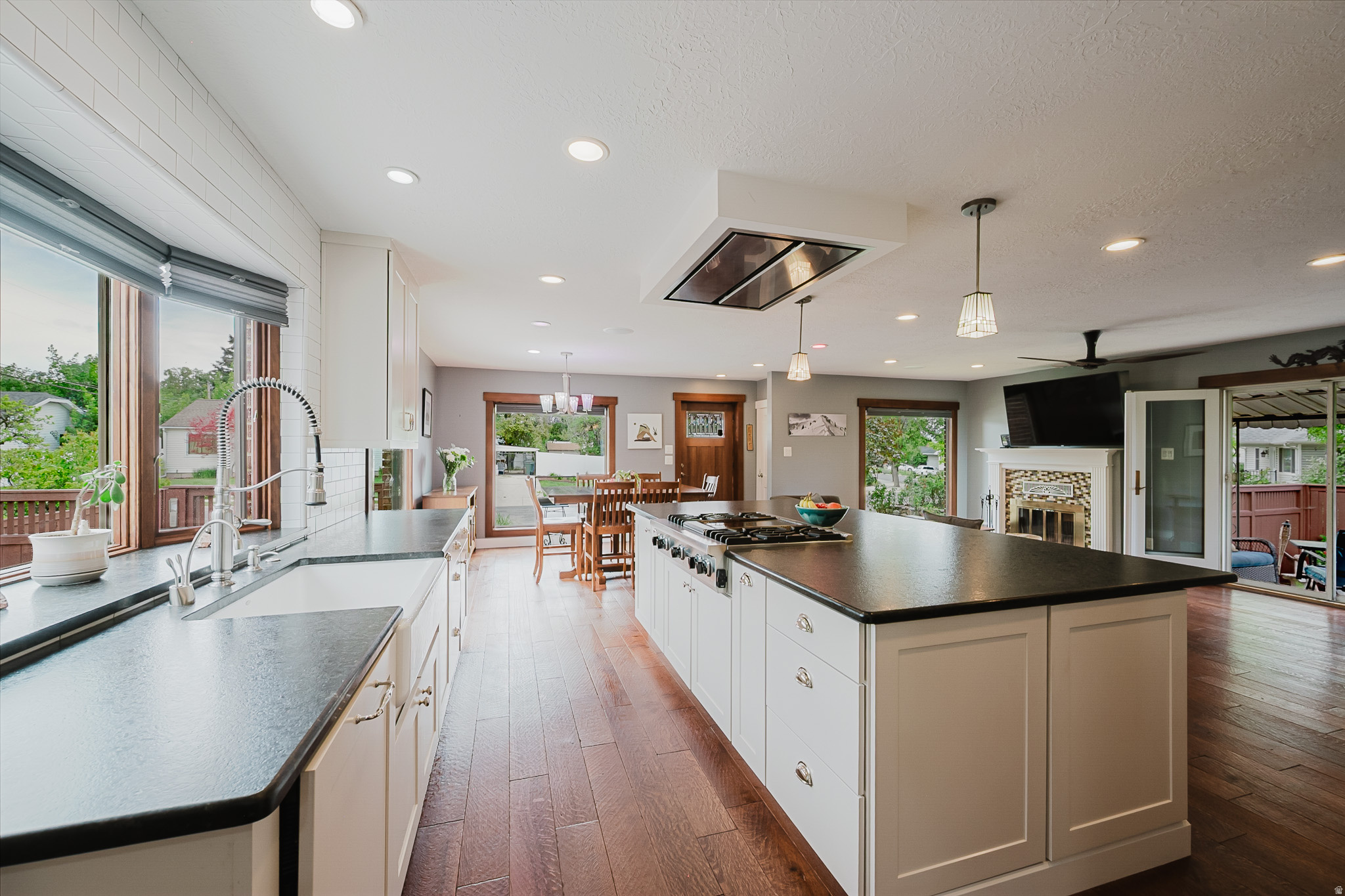 Showings begin at the open house Saturday, the 30th at 10:00. Rare Mill Creek home on a stunning .56-acre lot - this fully remodeled brick Cottage with mountain views combines timeless character with a ground-up renovation that left nothing untouched. New plumbing, new electrical, 95% high-efficiency HVAC with heat pump, on-demand tankless water heater, radon mitigation system, quarter-sawn solid oak hardwood floors, Andersen casement windows with matching quarter sawn oak casing, copper gutters on the front of home, whole house water filtration, hot water heater at kitchen sink,  two sets of French doors, a fireplace with Superior vent box and mosaic tile surround, Haiku smart ceiling fan, Philips Hue smart lighting, canned lighting, custom top-down/bottom-up blinds, and a beautiful mud room with bench, upper cabinetry, and coat hooks deliver the fit and finish of a true custom home. The gourmet kitchen is a showstopper - Viking 4-burner rangetop with griddle on the oversized island, KitchenAid combination microwave/convection wall oven, warming drawer, full stainless suite with French door refrigerator, honed granite countertops, shaker cabinets with custom hardware and soft-close hinges, commercial-grade vent hood with exterior venting, full subway tile backsplash, and a porcelain farmhouse sink beneath a breathtaking custom casement bay window that floods the space with natural light. The finished basement adds a spacious family room perfect for a second living area or media room. Outside, the property is truly one of a kind - three water shares with a private irrigation ditch, dual access points, and a pump keep the entire grounds lush at minimal cost, feeding six raised garden beds with a dedicated drip system, established fruit trees, grape vines, berry bushes, and sweeping perennial flower beds all framed by massive mature shade trees and a full cedar privacy fence with custom electric gate. The covered patio with awning, open deck, yard swings, and a hammock-ready backyard create effortless indoor-outdoor living, while the detached oversized 2-car brick garage with epoxy floors and attic storage, plus a separate storage shed, round out one of the most complete and compelling properties to hit the Mill Creek market in years. The home has been professionally inspected, and most deficiencies have been corrected. If the square footage or acreage of the property or improvements is of material concern to the buyer, the buyer is responsible for verifying the square footage/acreage measurements and improvements to the buyer's satisfaction.