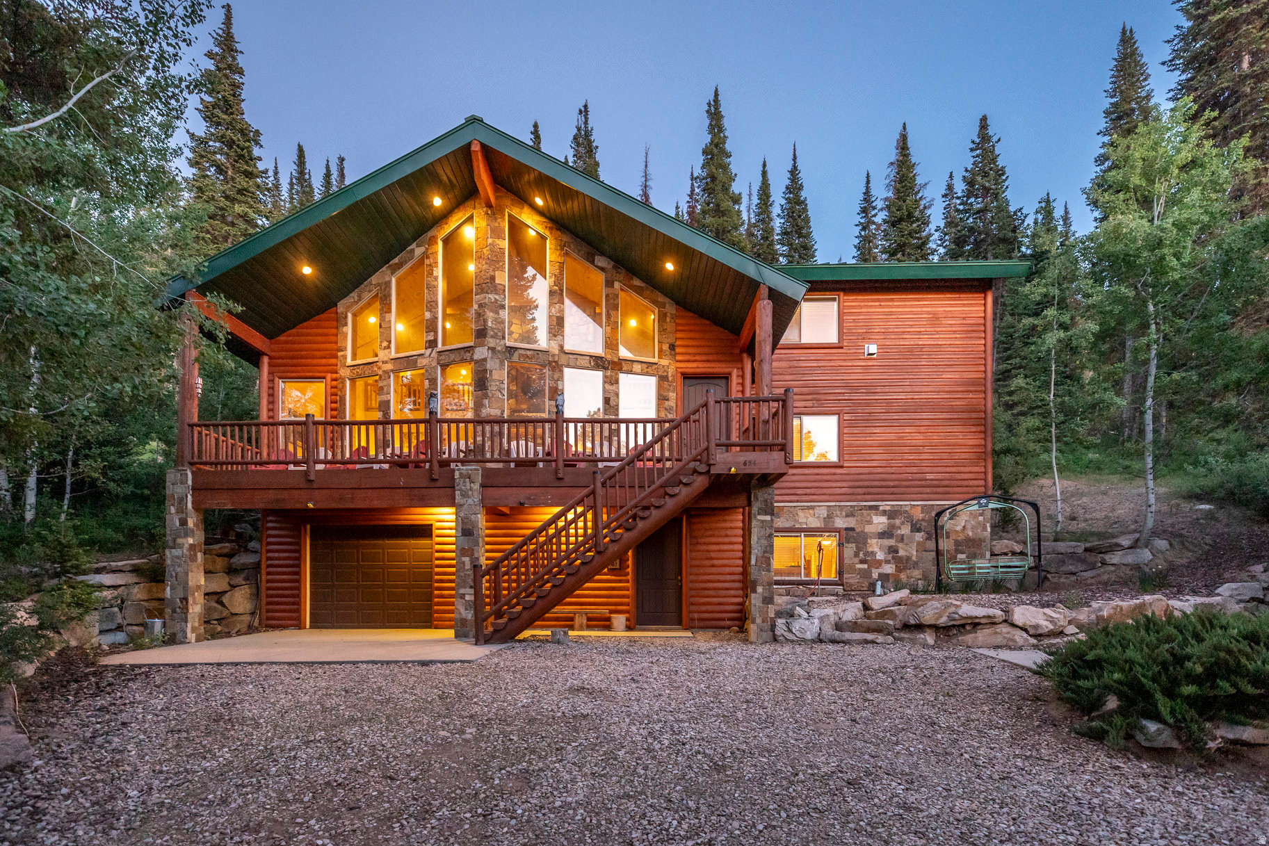Tucked among mature trees, scrub oak, and native vegetation, this timeless log cabin offers a rare opportunity to own a true sanctuary in the coveted Pine Mountain community of Oakley, Utah. Meticulously constructed by a builder for his own family, the quality and craftsmanship are evident in every log, beam, and finish. This property was designed to provide a peaceful and comfortable retreat to be enjoyed for generations. Built for both relaxation and recreation, the home offers a smart layout with four private bedroom suites plus an expansive bunk room featuring five custom beds, easily accommodating large groups or multi-generational gatherings. The great room is the heart of the home, with soaring ceilings, dramatic windows framing mountain and tree views, and a stone fireplace that anchors cozy moments and lively conversations. It flows seamlessly to the inviting front porch, perfect for quiet mornings or winding down under the stars. The open-concept kitchen offers ample prep space, a walk-in pantry, and informal dining that connects to a large covered deck ideal for grilling, lounging, and enjoying the serene outdoors. Upstairs, a spacious loft doubles as a media and game room with a fireplace, wet bar, and access to a second covered deck complete with power and ambient lighting for effortless entertaining. Practical comforts abound: a mudroom with gear storage and an extra fridge, a laundry room with two sets of washers and dryers, high-speed internet, sound system, and a full security setup. A detached "toy garage" offers oversized space for boats, snowmobiles, vehicles, and gear, plus a workbench area. Additionally, the seller holds a rare and transferable lease for a storage unit near the west gate, perfect for keeping snow equipment and transitioning between winter access and secure vehicle storage. Allowing winter access becomes part of the adventure, when the roads are closed to traditional vehicles, owners embrace the change in pace-riding in via snowmobile or tracked vehicle from the west gate for a truly immersive mountain experience. It's not a limitation, it's a lifestyle that deepens your connection to the cabin and surroundings. Outside, enjoy curated trails, a handcrafted fire pit, and a ski-lift chair turned reading nook, all inviting moments of rest and reflection. Located just 30 minutes from Park City and an hour from Salt Lake, Pine Mountain offers unmatched privacy and proximity to outdoor adventure. Enjoy nearby fly fishing on the Weber River, hiking and ATV trails, cross-country skiing, snowmobiling, and endless alpine recreation right outside your door.