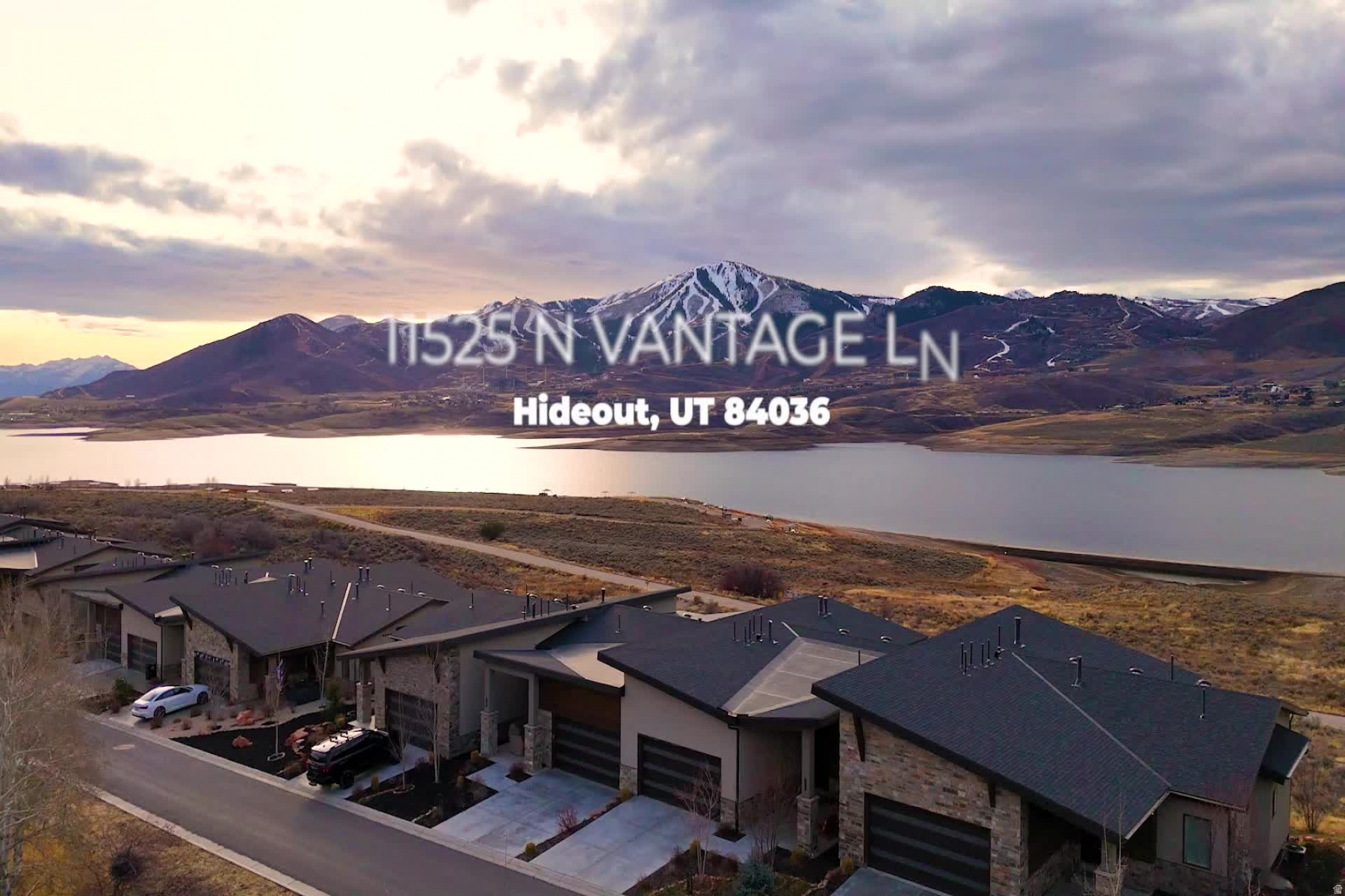 Unobstructed front-row views define life at 11525 N Vantage Lane 85 in Shoreline, Hideout, where Deer Valley ski runs, Jordanelle Reservoir, and the Wasatch peaks create a dramatic daily backdrop. Set on N. Vantage Lane in Wasatch County's 84036 corridor, this beautifully appointed 2021 townhome opens wide to the setting with large accordion glass doors and an expansive covered deck designed for sunrise coffee, sunset color, and clear mountain nights. Inside, 3 bedrooms and 3.5 baths unfold across 3,130 square feet of warm modern living. The main level centers on an open kitchen, dining, and living area with a generous island, gas fireplace, high-end appliances, upgraded flooring, designer lighting, automated shades, and oversized windows that keep the view present throughout the day. A main-level primary suite adds ease after time on the slopes, trails, or water, while the lower level extends the home with unobstructed views, a spacious living and entertaining area, private guest bedrooms and baths, and a media room. A two-car garage with EV charging and smart storage keeps skis, bikes, and lake gear organized. Turn-key option is available. Shoreline places mountain and reservoir living within easy reach of regional hiking and biking trails, Jordanelle water recreation, Deer Valley East Village, Park City Main Street, and Salt Lake City International Airport. With front-row scenery, refined interiors, and a low-maintenance mountain lifestyle, this Hideout retreat is ready to be experienced in person. Information deemed reliable but not guaranteed; buyer to verify all.