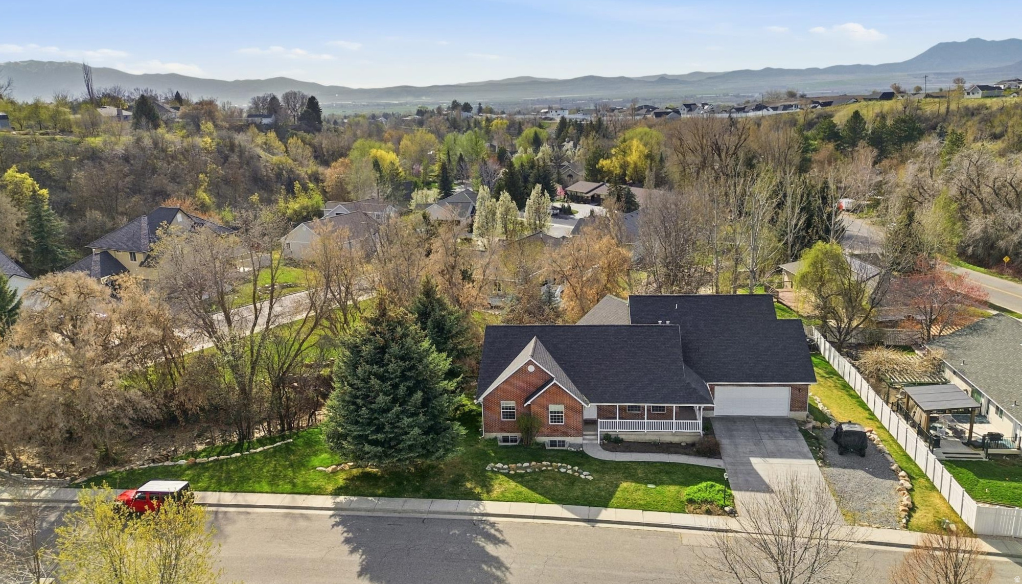 This beautifully updated home is set in a sought-after Birch and Smithfield canyon neighborhood and is what happens when comfort and style get together and build something amazing!  A large 1,200 sqft addition was completed in 2015, to include a kitchen with its own zip code.  We're talking enough space to host Thanksgiving, a baking show and a midlife crisis all at once.  Step outside onto the large deck and - you're in your own private retreat.  Mature trees surround the property like they are protecting something important.  There's even a peaceful vibes creek running through the backyard.  This home has space.  Like, actual space.  Enough for hosting, hiding from your kids, or finally starting that hobby you bought supplies for three years ago.  Updated throughout and a new roof in 2022, it blends modern touches with cozy canyon charm.  Close enough to civilization for groceries, far enough away to pretend you're off-grid and mysterious  the perfect mix of privacy and prestige.