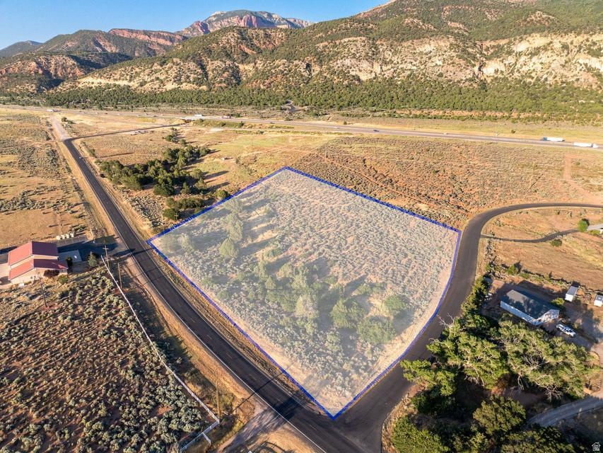 Discover 5 acres of buildable land in the heart of New Harmony with breathtaking mountain views and endless possibilities. Zoned RA-5, this corner parcel offers paved road access, no HOA, and the flexibility to bring your own builder. Community water is available with monthly fees of approximately $70-$80. Enjoy wide-open spaces, stunning natural surroundings, and room to create the lifestyle you've been dreaming of. Conveniently located with easy access to I-15 while still offering the peace and beauty of Southern Utah country living. Perfect for a custom home, hobby farm, or private retreat.