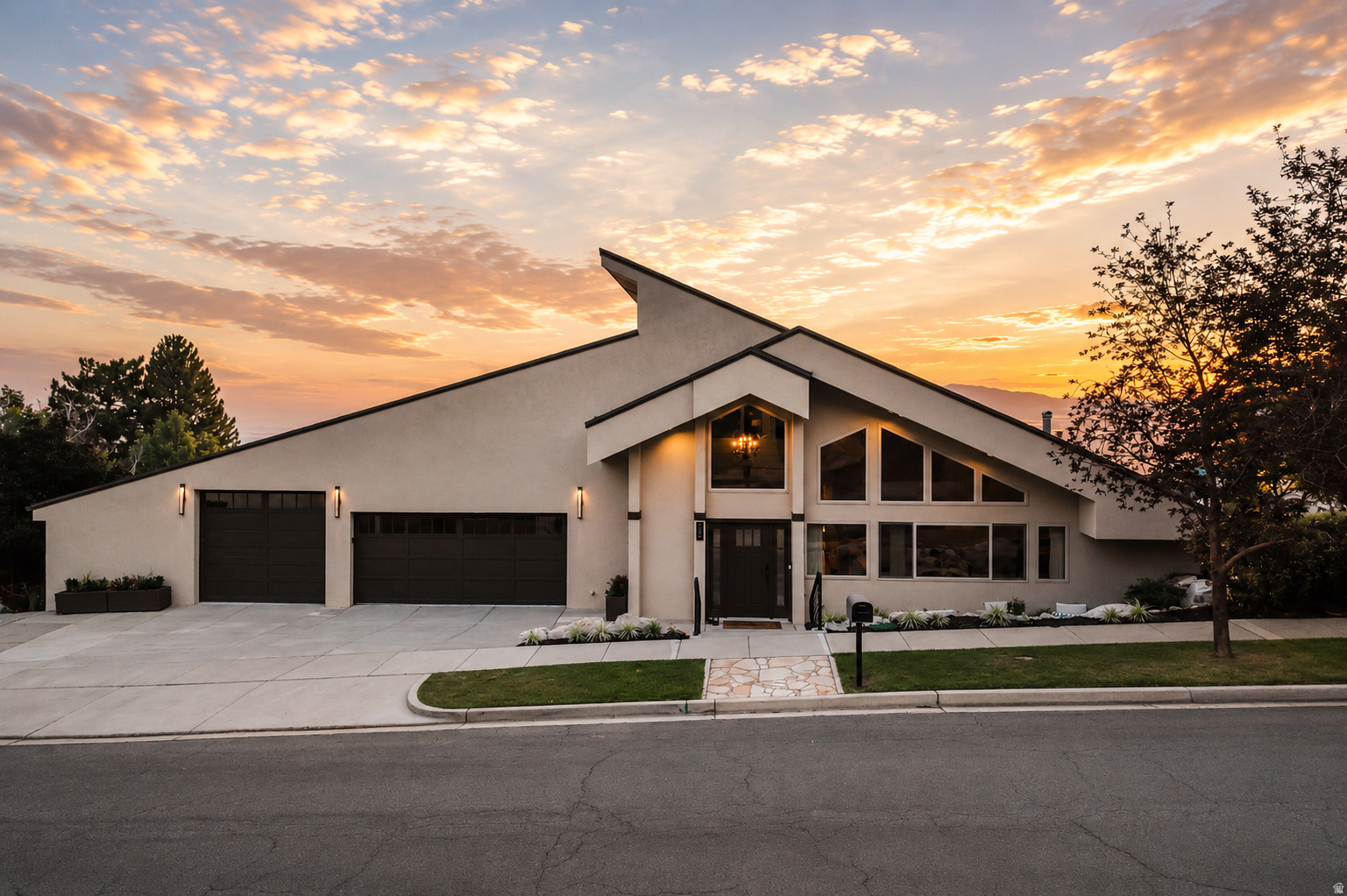 Perched in a highly sought-after Bountiful neighborhood, this 7,073 sq ft estate is designed to maximize natural light, open space, and some of the most breathtaking views in Utah.  From the east, you wake up to mountain views, sunrise, blue skies, and snow-covered slopes. To the west, the home opens up to sweeping Great Salt Lake views, unforgettable sunsets, the valley, Antelope Island, and the greater Salt Lake area. Every direction gives you something different, and every season feels beautiful here.  Inside, the home is filled with natural light all day long. With over 50 window panels and stunning clerestory windows, the main living spaces feel bright, warm, and open. At night, those same windows bring in moonlight, creating one of the most peaceful and unique settings you will find.  The architecture is timeless, with mid-century modern influence, high ceilings, clean lines, and high-end finishes that make the home feel both custom and comfortable. The grand room, living spaces, theatre, office loft, library loft, and large bedrooms give this home the kind of space that is almost impossible to recreate.  The layout is flexible and incredibly functional. With 5 bedrooms, 5 bathrooms, multiple gathering areas, oversized bedrooms, generous closet space, and room to sleep 15+ people if desired, the home works beautifully as a primary residence, family gathering place, or luxury retreat.  The lower level has its own separate entrance and can easily accommodate a mother-in-law apartment, guest quarters, or rental setup. The basement also has ADU potential, with the ability to create separate rental spaces while still keeping the main home private and functional.  Outside, the flat backyard is a rare find on the Bountiful Bench. There is room for kids, family, entertaining, a pool, hot tub, pickleball court, or simply enjoying the privacy, grass, and mature vegetation. The elevated west-facing balcony is one of the best features of the home, offering an incredible place to relax, entertain, and take in the sunsets. A second lower-level balcony gives you even more outdoor space with the same amazing views.  The garage and driveway are another major bonus. There is room for multiple vehicles, storage, toys, and guests, along with a large driveway and a high-end epoxy garage finish.  The location is hard to beat. You are close to top-rated schools, freeway access, Costco, Lowe's, Sprouts, Smith's, Natural Grocers, restaurants, trails, Snowbasin, downtown Salt Lake City, the airport, and the University of Utah hospitals. It gives you space, views, privacy, and convenience all in one of Bountiful's most desirable neighborhoods.  This is a rare combination of views, architecture, natural light, flexible living, and flat usable yard space, all in a location that continues to get better with time.