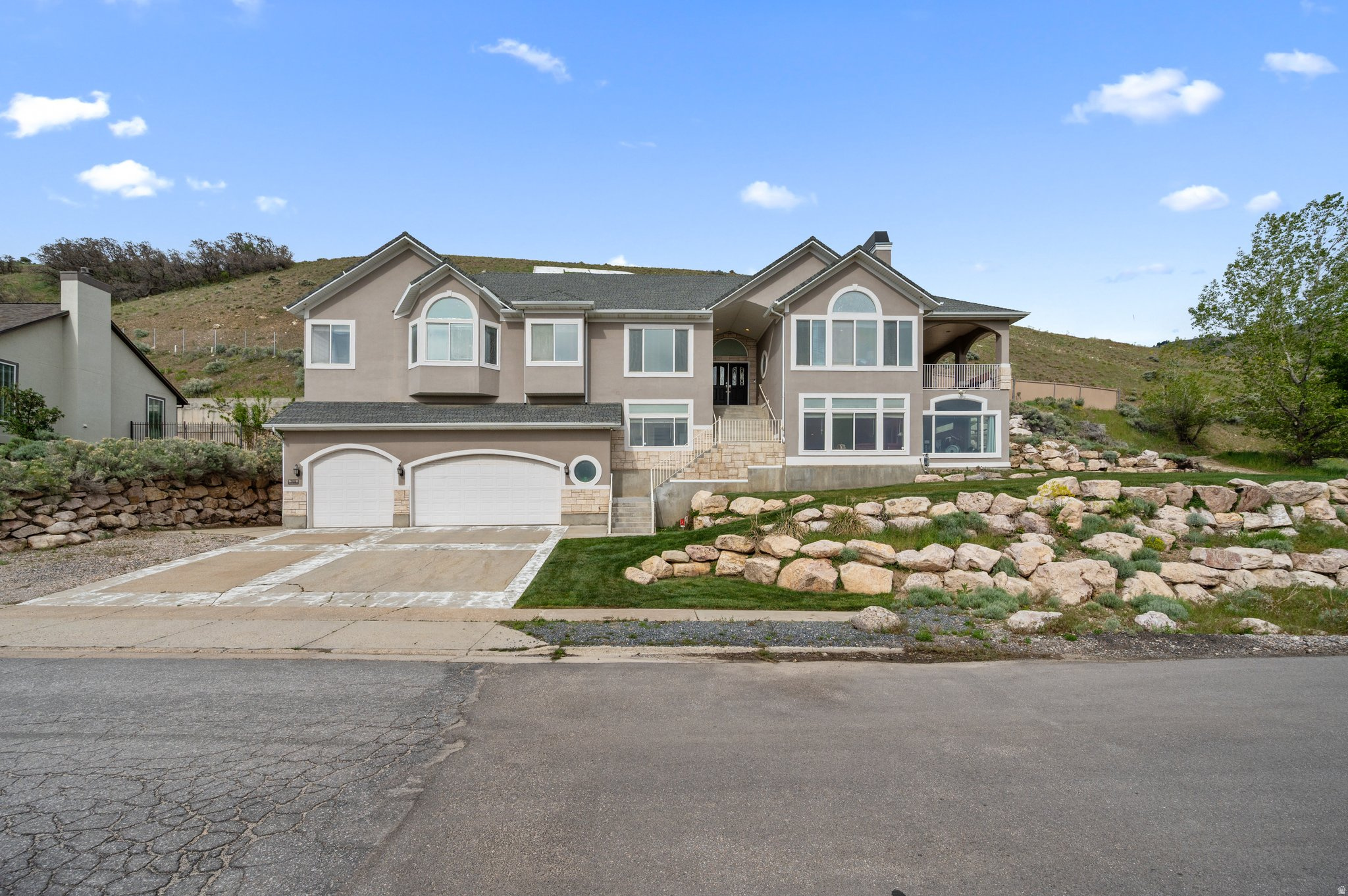 If you are looking for a fast getaway to the upper foothills of Bountiful to ride your ATVs and snowmobiles, or if you love to hike and do some camping out and have amazing views in all directions, this might just be the perfect home for you*This uniquely modern home is located just below the "B" and has the most spectacular views of the surrounding mountains and valley*Some of its amenities include: Five bedrooms*Two granite kitchens and upgraded appliances*Laundry on each floor*Home theater*420 sq. ft. home gym*Home office with more of those great  views*Covered deck with fireplace overlooking the valley*Three fireplaces*Concrete gun/safe room*Tool room and workshop*3 story shaft where elevator can be installed*Extra garage loft to store snowmobiles/ATVs*Basement level (level 1 in photos) of home is entirely garage-storage areas*Level 2 square footage is combo of finished living space and the lower level garage/storage*Square ftg and all other info to be verified by Buyer*