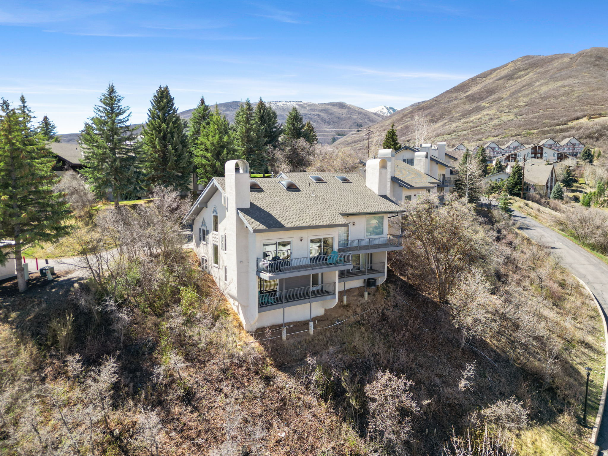 Buyer may be eligible to receive up to $3,000 in lender credits when financing through the seller's preferred lender, subject to lender terms, approval, and qualification.  Nestled within the prestigious Swiss Oaks enclave, this meticulously maintained residence offers a rare combination of main-level living and expansive, panoramic views that define the Midway lifestyle. Positioned to capture the dramatic silhouette of the Wasatch Mountains and the manicured fairways of the adjacent Homestead Golf Club, the home serves as a private sanctuary where indoor comfort meets the rugged beauty of the surrounding peaks. The 2,210-square-foot interior transitions effortlessly from an open-concept living space with vaulted ceilings featuring amazing skylights and a cozy fireplace to a fully finished basement. Expansive windows and two private decks offer the ultimate vantage point for enjoying the crisp mountain air and unobstructed vistas. The beautiful natural grounds are adorned with mature trees, pines, and scrub oak, enhancing the property's natural charm. Residents enjoy an unparalleled resort-caliber amenity package including a clubhouse, hot tub, dry sauna, gym, and courts for pickleball and tennis. High-speed internet and water costs are paid by the HOA, as well as snow removal.