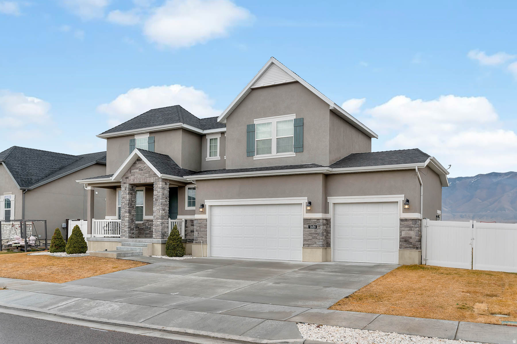 Rare 7-Bedroom Gem: The Perfect Blend of Space, Style, and Serenity!  Welcome to 5686 N Duke Ln, a home that truly offers the "best of both worlds." Located in the highly sought-after Stansbury Park, this 2021-built home delivers a peaceful, quiet-country feel without sacrificing the modern conveniences you love.  The Layout You've Been Searching For: This 2-story floorplan is a masterclass in convenience. The Primary Suite AND the Laundry Room are both located on the main level-a massive advantage for easy, daily living. The Primary Retreat is a true escape, featuring a spacious layout and an en-suite bath with a full soaking tub and separate shower.  Space for Everything & Everyone:  Gourmet Heart of the Home: A spectacular, open kitchen with endless counter space flows into a beautiful great room anchored by a cozy fireplace.  7 True Bedrooms: Whether you need guest rooms, a hobby space, or a home gym (one basement bedroom is already perfectly set up for your workouts!), this home adapts to you.  Work from Home Ready: The bright living room to the left of the front entry is an ideal executive office or formal sitting area.  Outdoor Living & Community: Situated on a large lot, the backyard is built for gatherings. Enjoy summer barbecues on the newer, expanded concrete patio with plenty of room for everyone to spread out.  Why Stansbury Park? Stansbury Park is Utah's hidden gem-offering a super-quiet, "small town" atmosphere while being just 25 minutes from Salt Lake City. You get the fresh air and starry nights of the country, combined with a community that features multiple local lakes for afternoon walks, parks, and brand-new shopping and dining popping up just minutes away.  Bonus: This home is USDA 100% Financing Eligible, making it an incredible opportunity for qualified buyers.  Don't miss your chance to own a nearly-new home with 7 bedrooms and a main-floor master in one of the most balanced communities in the state!