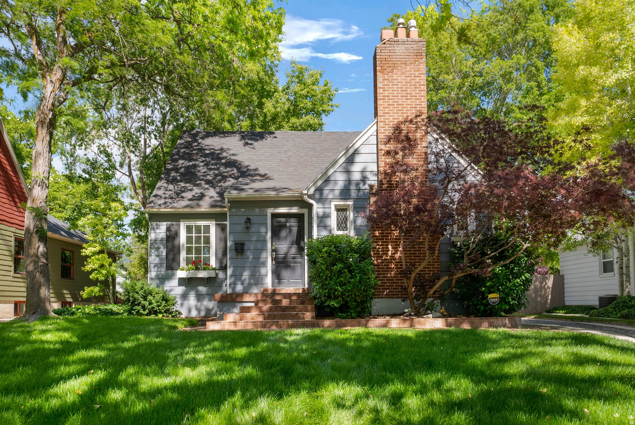Located in the highly desirable ABC Streets of Sugar House, this charming two story home blends timeless character with thoughtful updates throughout. A welcoming entryway with graceful rounded archways opens to a spacious, light-filled living room featuring beautiful leaded glass windows, new Pella windows, hardwood floors, and a cozy gas fireplace as its centerpiece.The adjacent formal dining room overlooks the expansive backyard through additional new Pella windows. The eat in kitchen offers thoughtfully designed counter space, newer oak cabinetry, stainless steel appliances, and direct access to multiple decks, creating an ideal setting for indoor outdoor living and entertaining,The main level also features a versatile bedroom or den and a full bathroom. Upstairs, you'll find two generously sized bedrooms, each equipped with recently installed HVAC systems, along with a full bathroom and new windows throughout.The lower level includes a bright bedroom with high ceilings, a three-quarter bathroom, a laundry room, and abundant storage space. Outside, the spacious backyard offers endless possibilities, with room for gardening, entertaining, or future expansion. Mature shade trees, multiple deck areas, and a peaceful setting make this outdoor space especially inviting.Additional features include a one-car garage with an automatic opener, updated windows throughout much of the home, and an exceptional location in one of Sugar House's most sought-after neighborhoods. Quaint restaurants, coffee shops, and local amenities are within walking distance, while the University of Utah, downtown Salt Lake City, and Salt Lake City International Airport are all just a short drive away.  Square footage figures are provided as a courtesy estimate only.  Buyer is advised to obtain an independent measurement.