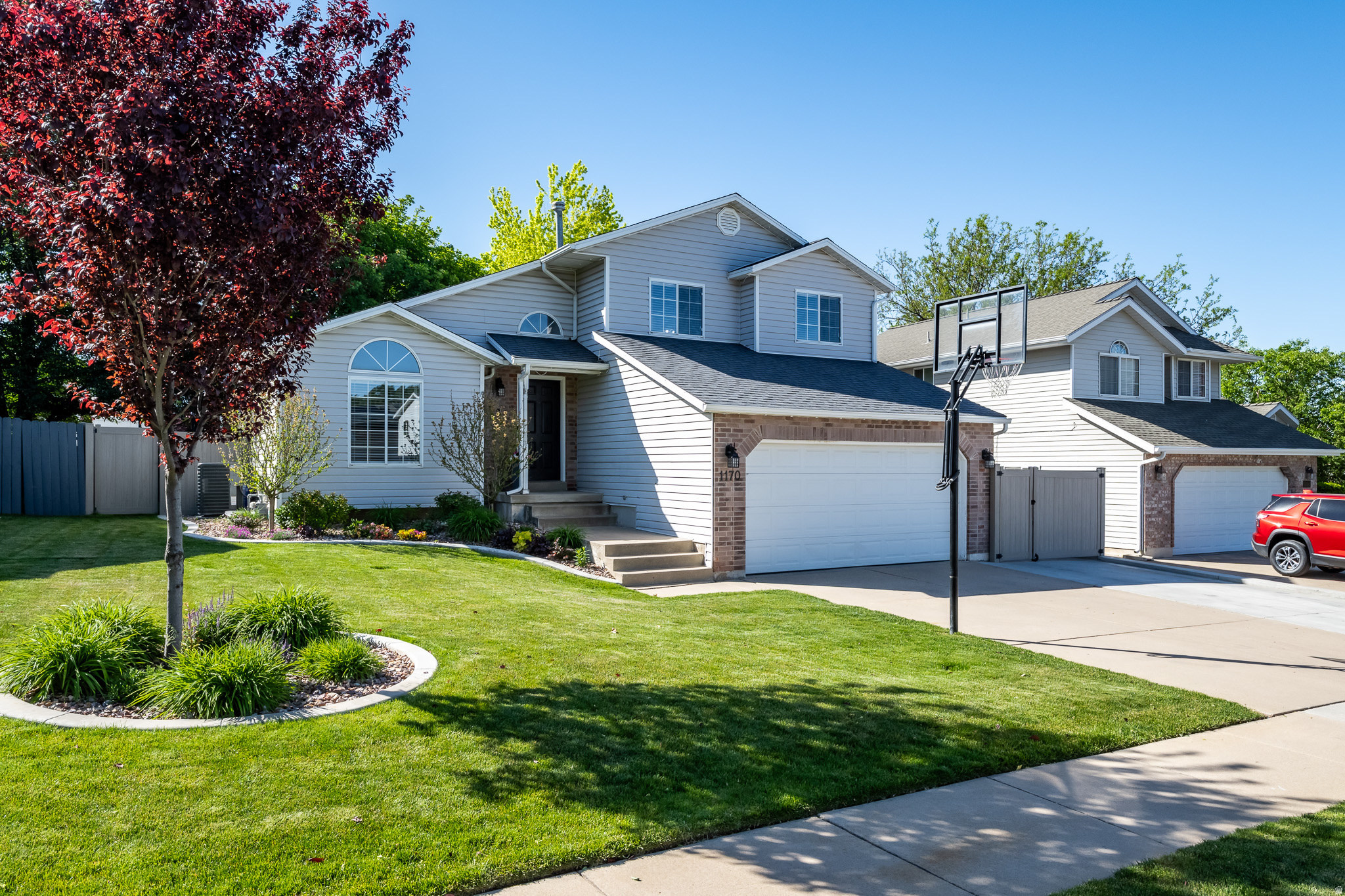 Beautifully updated home with thoughtful upgrades inside and out! The spacious primary suite features a fully remodeled bathroom and custom closet, while the upstairs hall bath has also been tastefully refreshed. The finished basement was reconfigured for improved functionality and flow, complete with new paint and carpet. Major mechanical updates include a new furnace and A/C in 2025 and a water heater replaced in 2018. Outside, the property has been completely transformed with extensive new landscaping and hardscaping, including a new patio, sprinkler system, curbing, sod, underground drains, and permanent outdoor lighting. The fully fenced yard features a concrete mow strip for durability and clean maintenance. RV owners will love the new RV pad with water hookup and 50-amp power. Additional upgrades include new gutters with gutter guards, fresh plants and rock beds, and a relaxing hot tub perfect for entertaining or unwinding at home. Conveniently located with quick access to Hill Air Force Base and an easy commute to downtown Salt Lake City, this home combines comfort, functionality, and location in one exceptional package.