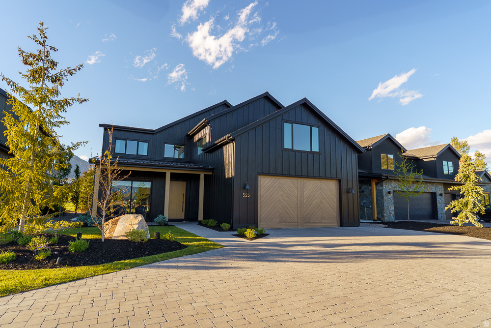 Experience elevated mountain modern living in this one-of-a-kind custom home backing directly to protected open space with unobstructed views of Snake Creek that will never be disturbed. Thoughtfully designed with exceptional attention to detail, this residence blends warmth, luxury, and functionality throughout.  Premium finishes include white oak hardwood floors, white oak ceilings spanning the main level, extensive stone accent walls, Venetian plaster, 8-foot solid core doors, and dimmable lighting throughout. The dramatic great room features 24 feet of stacking glass doors that fully open to the outdoor living space, creating seamless indoor-outdoor living surrounded by breathtaking natural views.  The chef's kitchen is equipped with top-of-the-line Wolf and Sub-Zero appliances, including a Wolf steam oven, oversized griddle, prep kitchen with secondary sink and hidden trash storage, and a spacious walk-in pantry.  The home offers 5 bedrooms, 4.5 bathrooms, a dedicated office, playroom, craft room, gym, upstairs storage room, and second-floor laundry. The luxurious primary suite features a striking concrete soaking tub, while concrete sinks add designer character to the main-level bathrooms.  The professionally designed backyard is an entertainer's dream with premium pavers, an 8-foot firepit, sauna, cold plunge, and 8-person hot tub-all included. Crate & Barrel outdoor couches create a turnkey outdoor retreat surrounded by mature pine trees, while a rock fountain and extensive front paver work complete the exceptional curb appeal.  Additional highlights include a whole-home speaker system, aluminum-clad windows, 85" Samsung Frame TV with surround sound, and an oversized 996 sq ft extra-deep 3-car garage with custom lockers, workbench, storage, and task lighting.  This thoughtfully curated luxury home was intentionally designed for refined everyday living.
