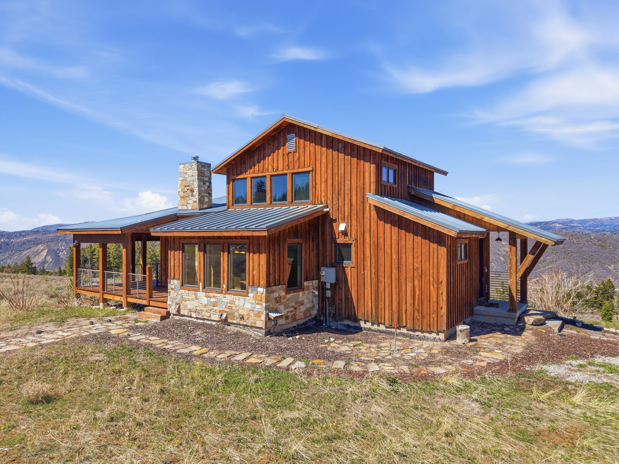 Experience refined mountain living at 8,400 feet with this exceptional mountain modern luxury cabin set on 10 pristine acres. Perfectly positioned to capture breathtaking, unobstructed views in every direction, this property offers a rare balance of privacy, space, and connection. Designed with both comfort and entertaining in mind, the thoughtfully crafted floor plan provides seamless gathering spaces while still offering quiet retreats. You'll love the butler's pantry and additional food prep space. Expansive windows invite the outdoors in, filling the home with natural light and showcasing the surrounding landscape in every season. High-end appliances and elevated finishes are found throughout, creating a level of quality and design that complements the setting. Enjoy year-round access along with modern conveniences including fiber internet to stay connected, reliable power, and a well-managed HOA-allowing you to fully embrace mountain living without sacrificing everyday comfort. Radiant heated floors provide warmth and efficiency, making the home as inviting in the winter as it is refreshing in the cooler mountain summers. Whether you're escaping the heat of summer or settling in for snow-covered winter days, this cabin delivers a true four-season experience. Nestled among mature trees yet intentionally positioned to preserve views and openness, this is mountain living without compromise. The roads are plowed weekly during winter according the the CC&Rs, but snow machines will certainly help you access the cabin.