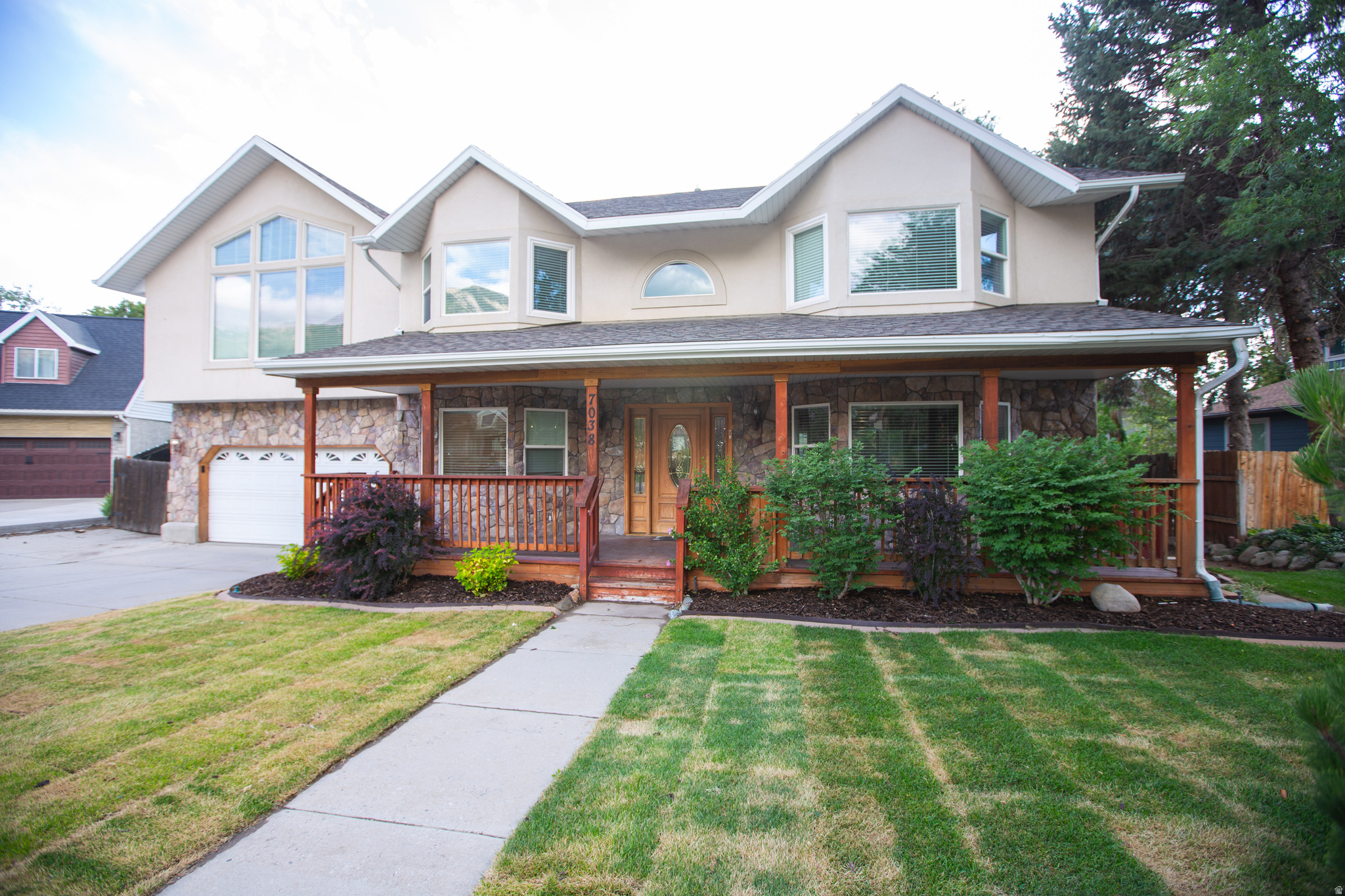 Beautifully updated 5-bedroom home nestled on a quiet cul-de-sac in one of Cottonwood Heights' most desirable neighborhoods. This move-in ready home has been thoughtfully refreshed with a remodeled bathroom, elegant granite kitchen countertops, fresh interior paint, new carpeting, updated landscaping featuring a new front lawn, fresh mulch, and attractive new plantings that create exceptional curb appeal. The spacious floor plan offers generous living areas designed for both everyday living and entertaining. The bright kitchen includes a large pantry and opens to comfortable gathering spaces, while the fully finished basement provides additional room for family activities, a media room, home office, or guests. The spacious bedrooms offer flexibility for growing families or work-from-home lifestyles, and the updated primary suite features a beautifully remodeled bathroom with a custom tile shower surround. Step outside to enjoy the inviting covered front porch or relax in the private, fully fenced backyard complete with a large entertaining deck, fire pit, mature shade trees, and an in-ground trampoline. The generous yard offers plenty of room for gardening, outdoor recreation, or creating your own backyard retreat.  Located in the heart of Cottonwood Heights, this home provides quick access to shopping, restaurants, parks, and major commuter routes including I-215. Outdoor enthusiasts will appreciate being just minutes from Big and Little Cottonwood Canyons, offering year-round recreation including world-renowned skiing, snowboarding, hiking, mountain biking, climbing, and scenic alpine destinations. The convenient location also provides easy access to downtown Salt Lake City, Silicon Slopes, and Salt Lake International Airport.  This exceptional home combines modern updates, generous living space, an outstanding location, and the outdoor lifestyle that makes Cottonwood Heights one of Utah's most sought-after communities. Schedule your private showing today!