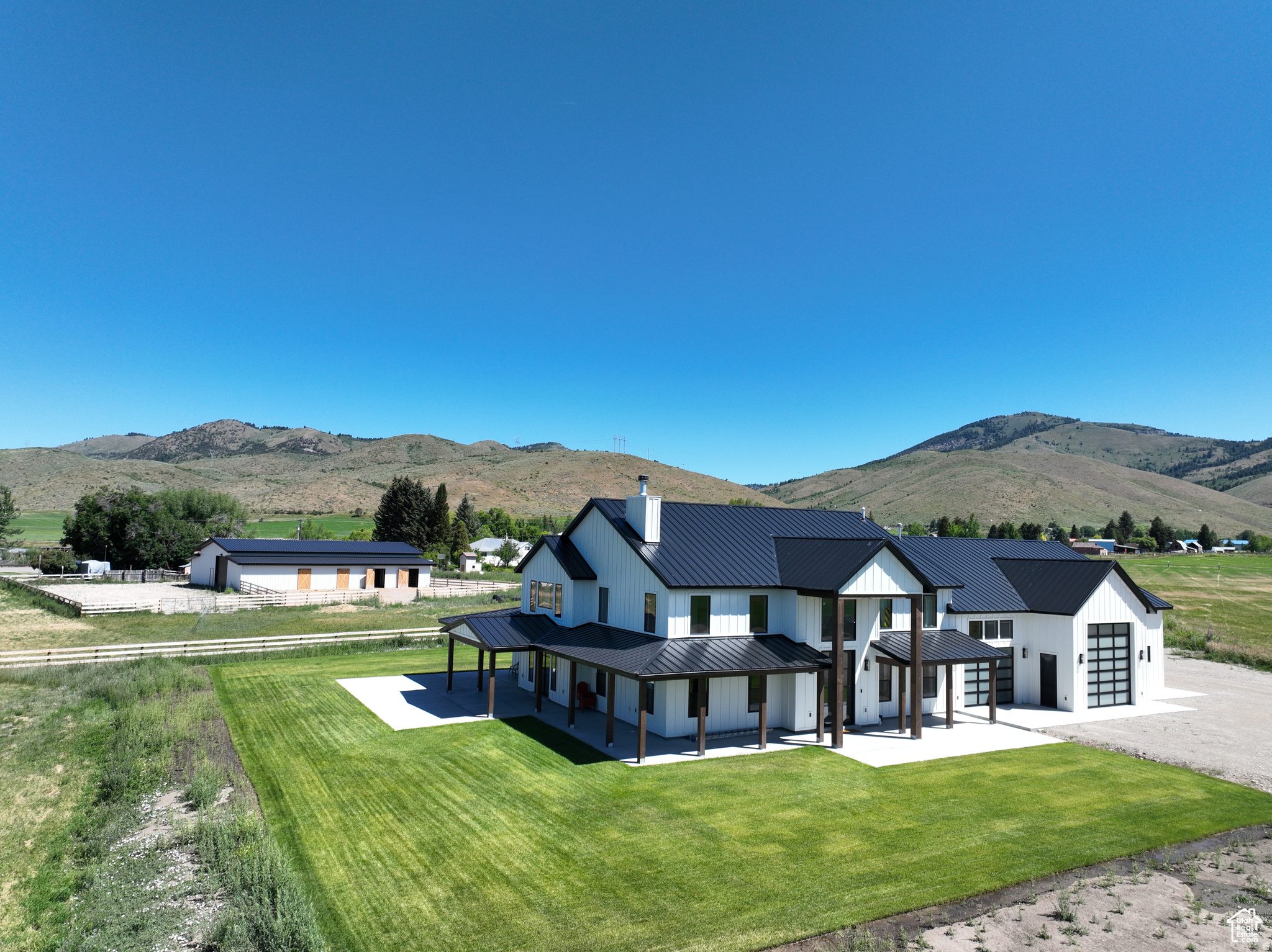 Brand new custom built modern farmhouse on 5.35 acres with 4 water shares. 5 bed 2.5 bath with the potential to be a 6 bedroom if needed would make the perfect primary residence or investment property. The garage is something of dreams being over 2600 sq feet with 13 foot garage doors making it easy to store all your toys. Main level in floor radiant heat, tankless water heater, central vac with self retracting hose system, laundry drop in master, butlers pantry with built in wolf microwave & scotsman ice maker, subzero fridge/freezer combo, 60 inch wolf range , pot filler for water, Marvin metal windows, laundry on both floors and so many more upgrades. Home is also sold with a 50 X 80 steel barn. 4 doors for stalls, chicken run and 2 outside bays, 3 auto garage doors and man doors on each side, lighting and electrical, water inside and out, 4 slat wood fence making it the perfect set up for your hobby farm. Contact listing agent for a full list of home and shop features