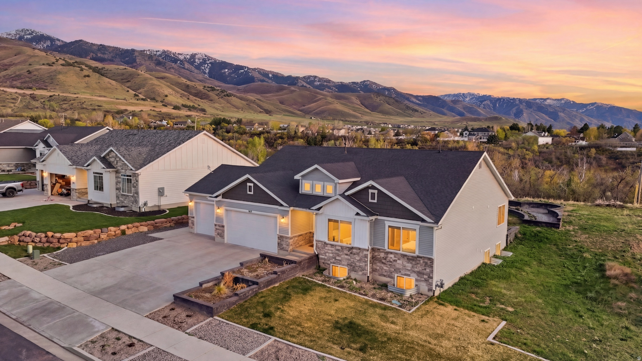 Motivated Seller! Stunning Custom-Built Home in Smithfield! This exquisite, fully finished residence offers breathtaking views, spacious living, and exceptional features that make it a true gem! Enjoy stunning sunsets and sunrises over the mountains and valley from your own backyard.  With two family rooms and an over-sized primary bedroom, this home boasts ample space for relaxation and entertainment. The heart of this home is the beautiful gourmet kitchen, complete with double ovens, generous storage, and elegant finishes. The primary bathroom features a separate shower and luxurious amenities, along with walk-in closets for all your personal storage needs. The garage is equipped with hot and cold water, and there are plugs behind all toilets for future bidet installations. A dedicated electrical stub for a gazebo kitchen and patio connections for a future hot tub enhance your outdoor living experience. Meticulously crafted landscaping, planter boxes, sprinkler system, grass, back patio over looking the valley, and landscaping plans ensure your outdoor space is as beautiful as the interior. Landscaping is 75% complete!  All TVs and mounts are included, providing you with a seamless move-in experience. This immaculate home is in pristine condition and offers an unparalleled lifestyle. Don't miss your chance to own this incredible property! Schedule your showing today!
